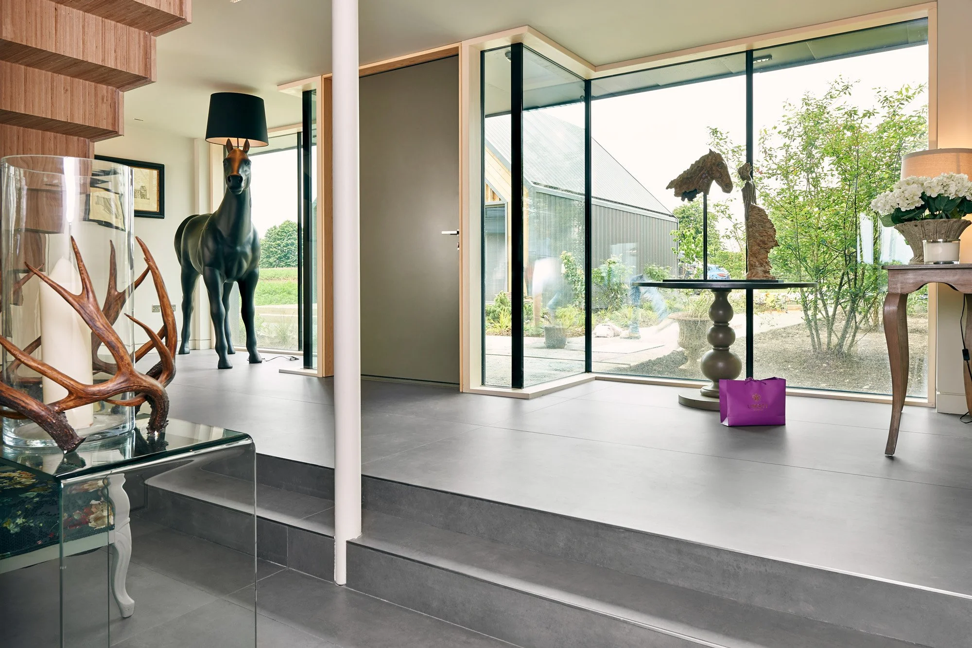 Modern interior featuring large concrete look porcelain tiles.
