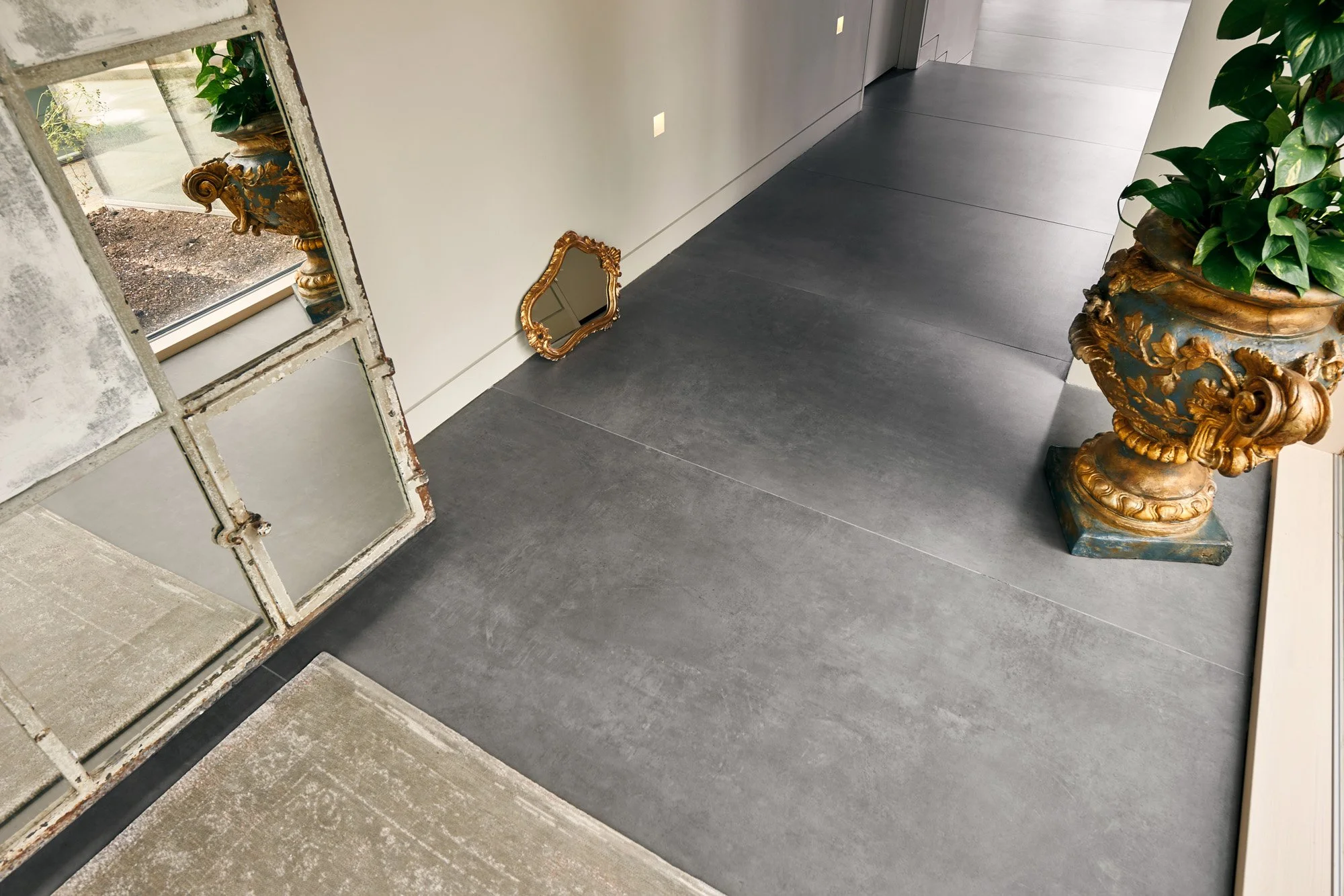 Matte concrete look porcelain tile installed in an open-concept living space.