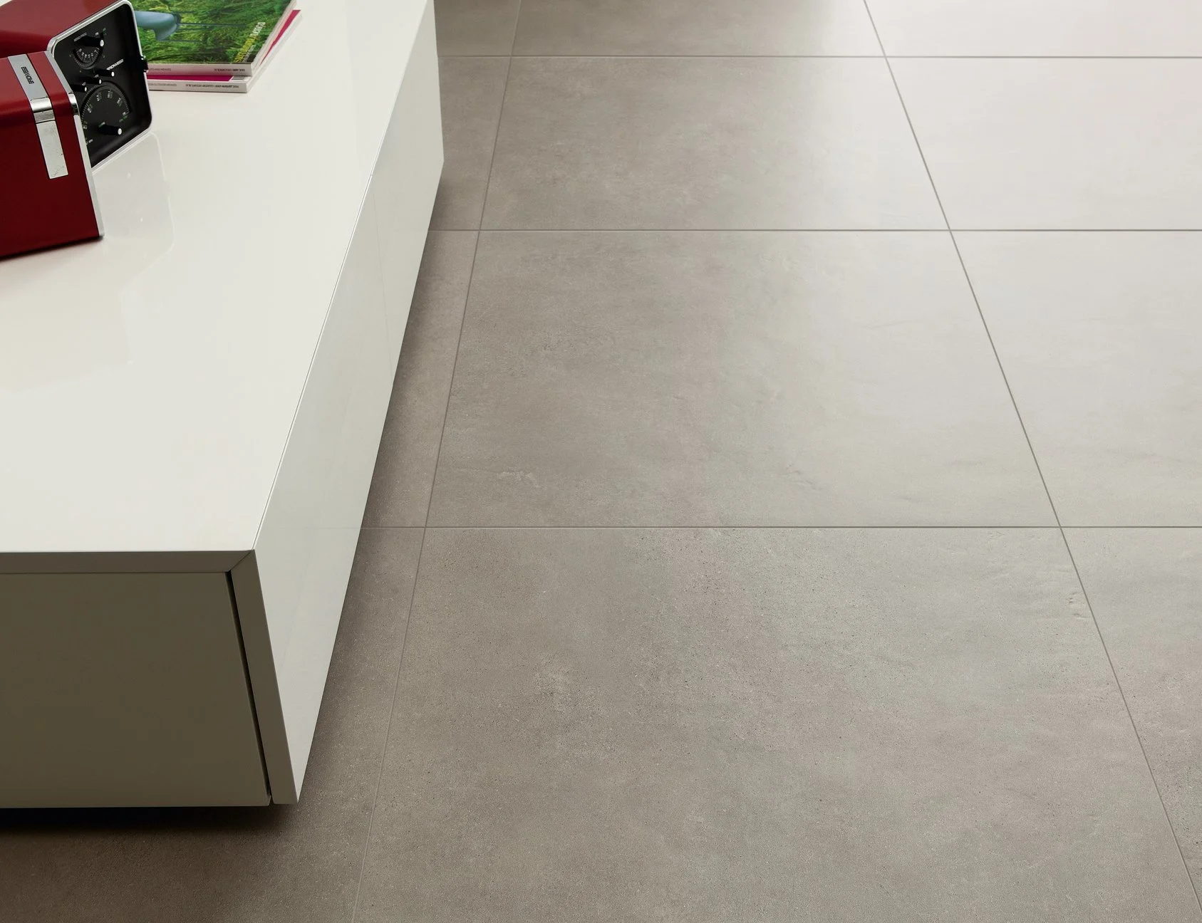 Contemporary living space featuring concrete look porcelain tile by Sapphirus Stone & Tile.