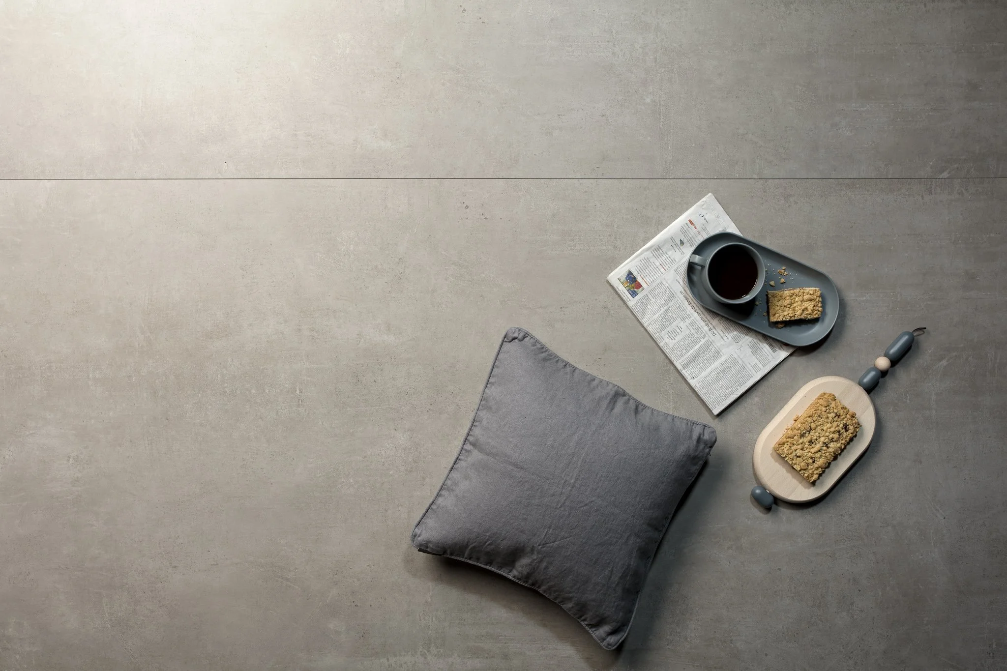 Concrete look porcelain tile floor creating a cohesive modern design.