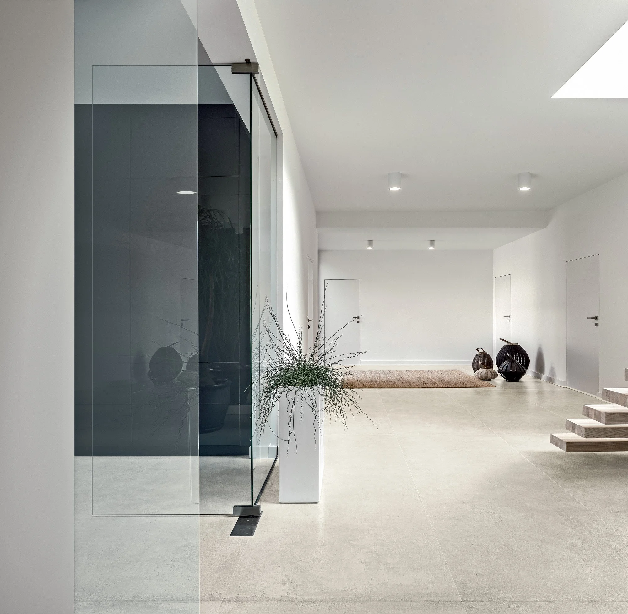 Modern architectural interior enhanced with concrete look tile flooring.