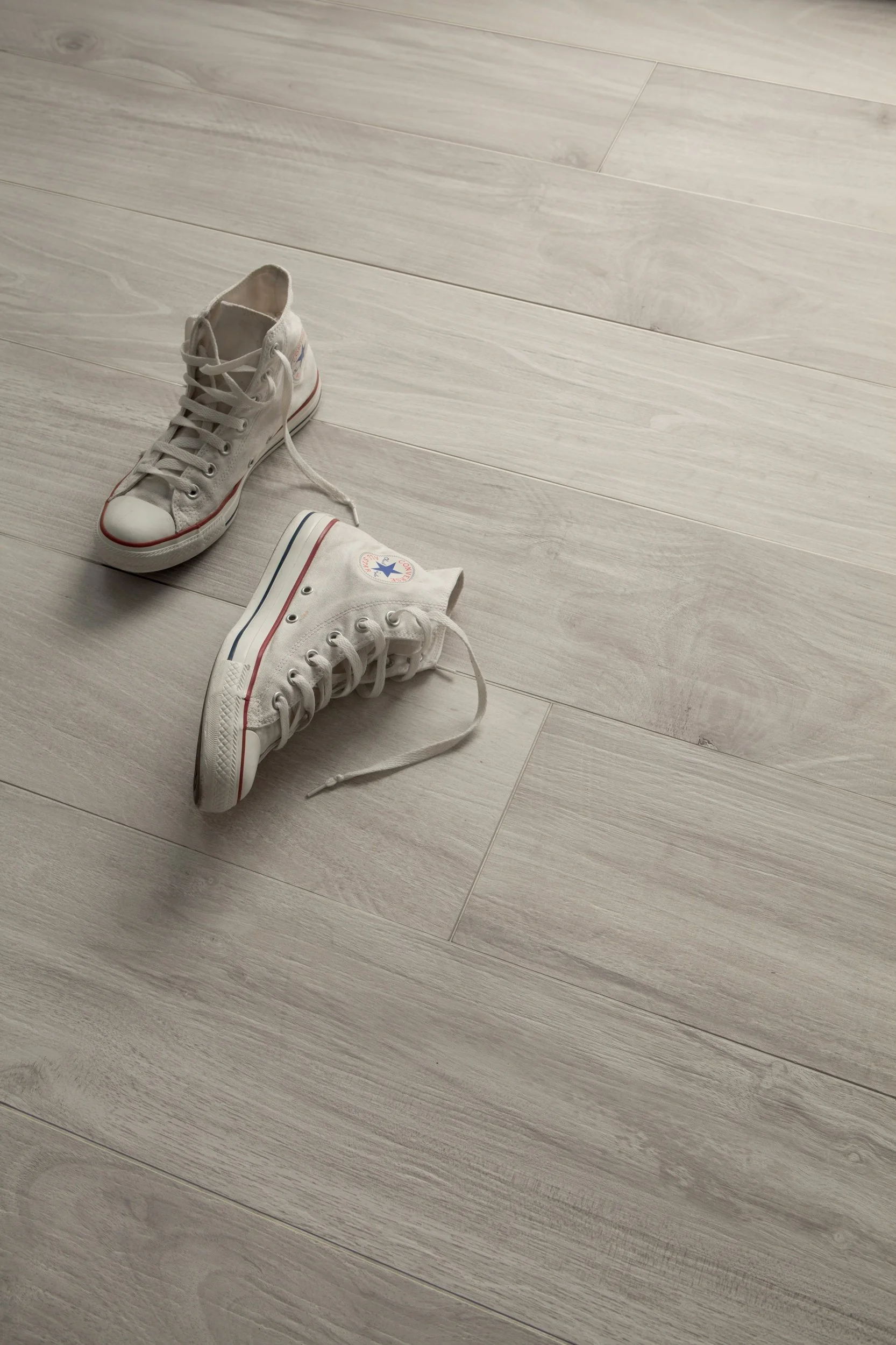 Clean modern interior featuring wide plank wood look porcelain tile flooring.