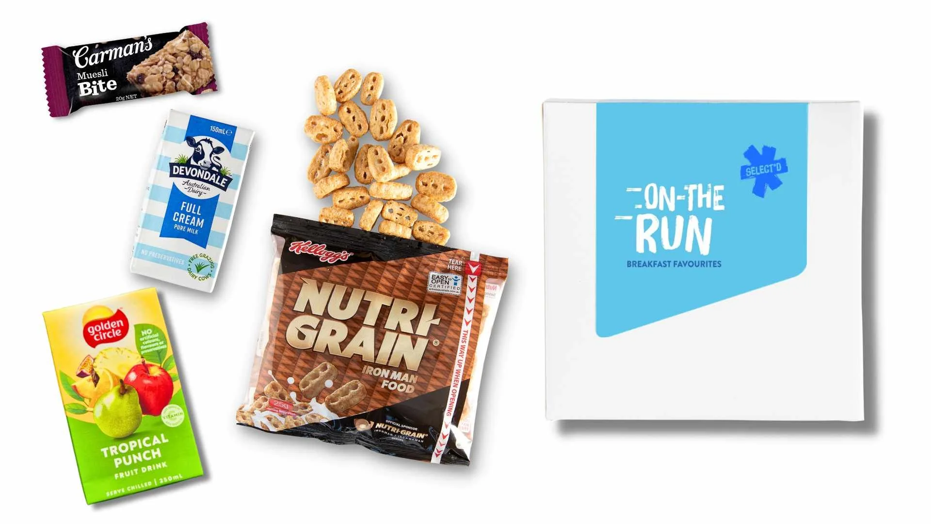 An assortment of breakfast items including Carman's Muesli Bite bar, Devondale Full Cream Milk, Kellogg's Nutri-Grain cereal, Golden Circle Tropical Punch fruit drink, and a box labeled 'On-The-Run Breakfast Favorites.'