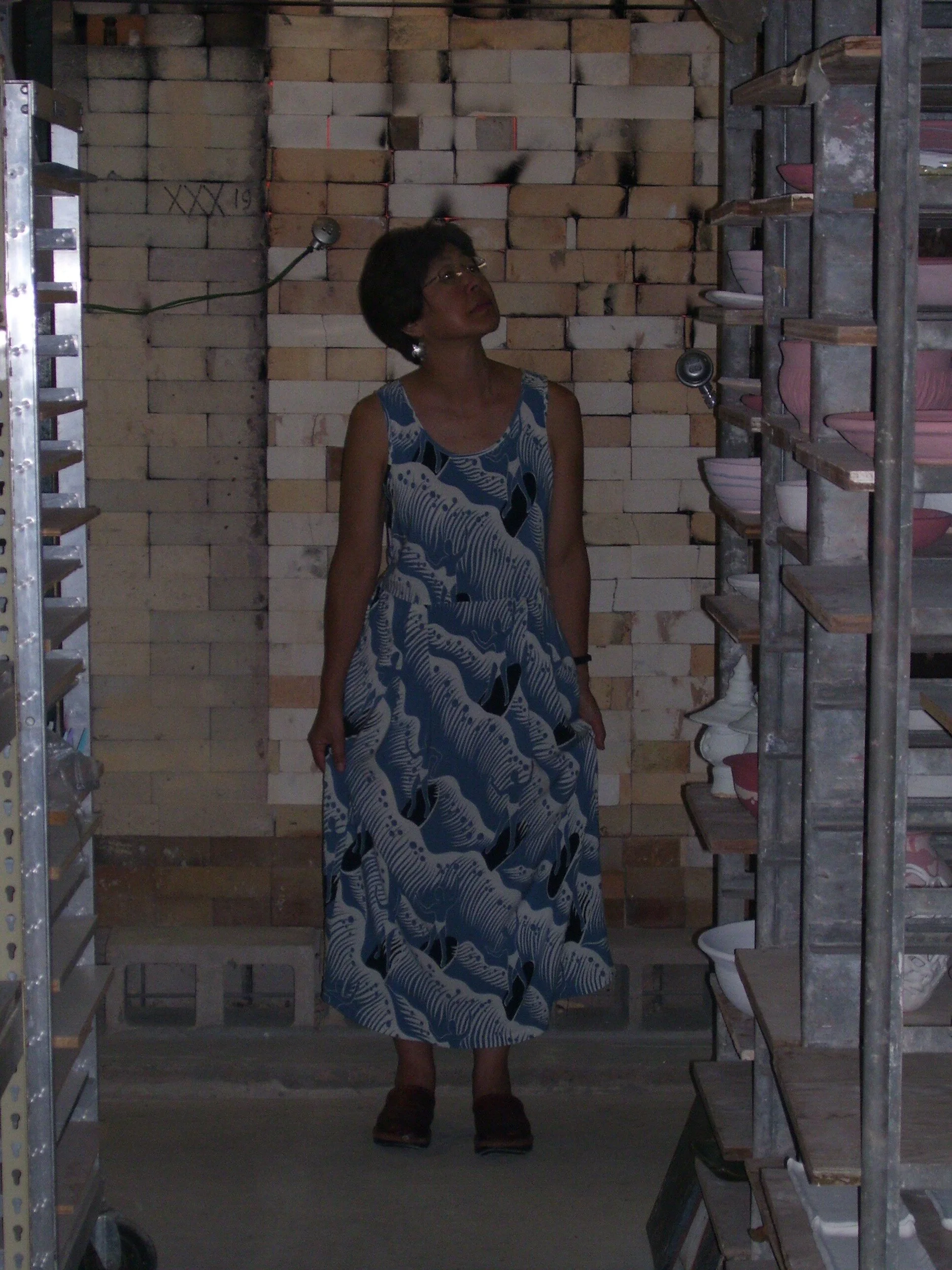 Maile getting warm in front of kiln.JPG