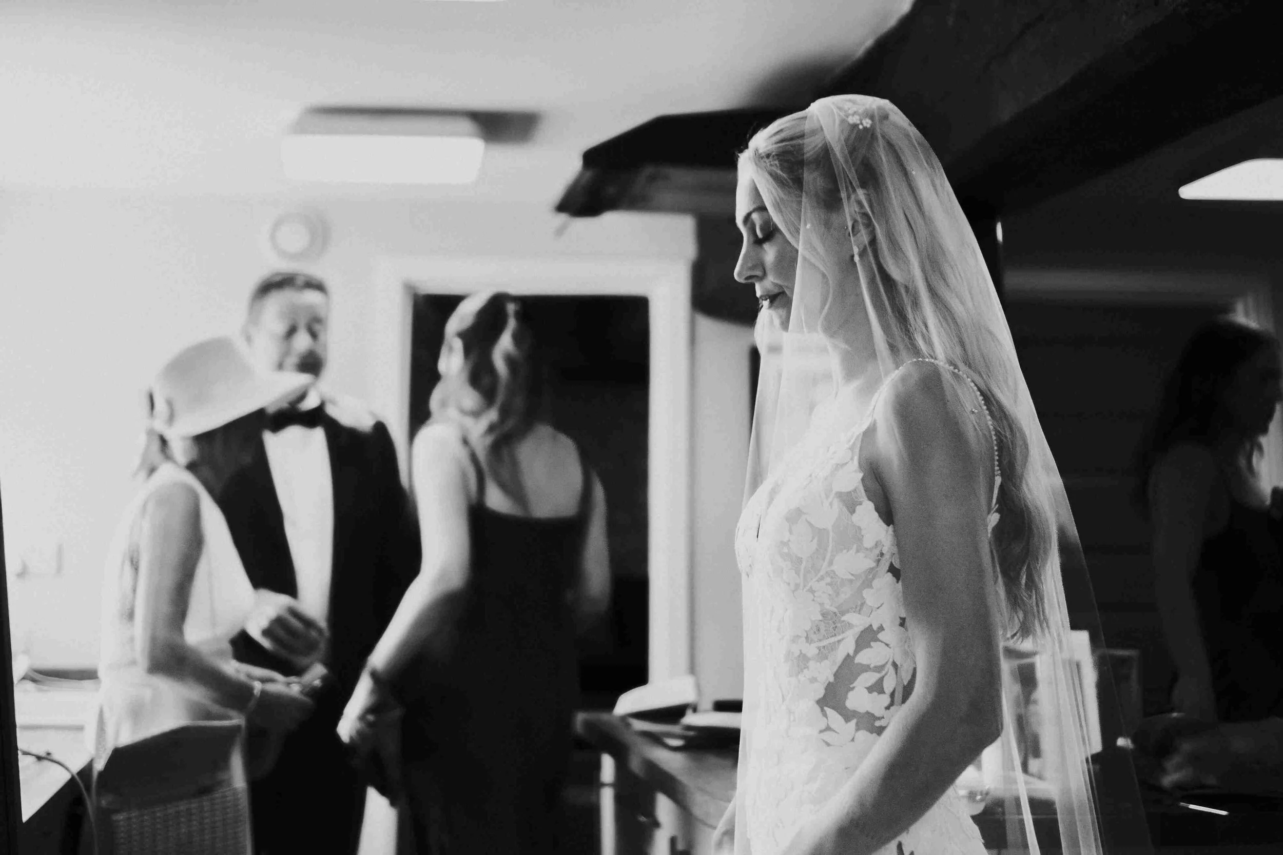 Bride standing in the kitchen with her eyes closed taking a deep breath  before her Halfmoon Farm Wedding in Rutland