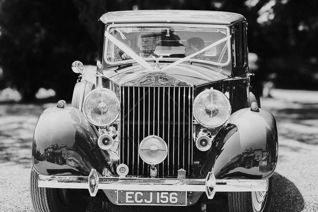 A view of the Rolls Royce Wedding car arriving with the bride and her father for a Hampton Court House Wedding.