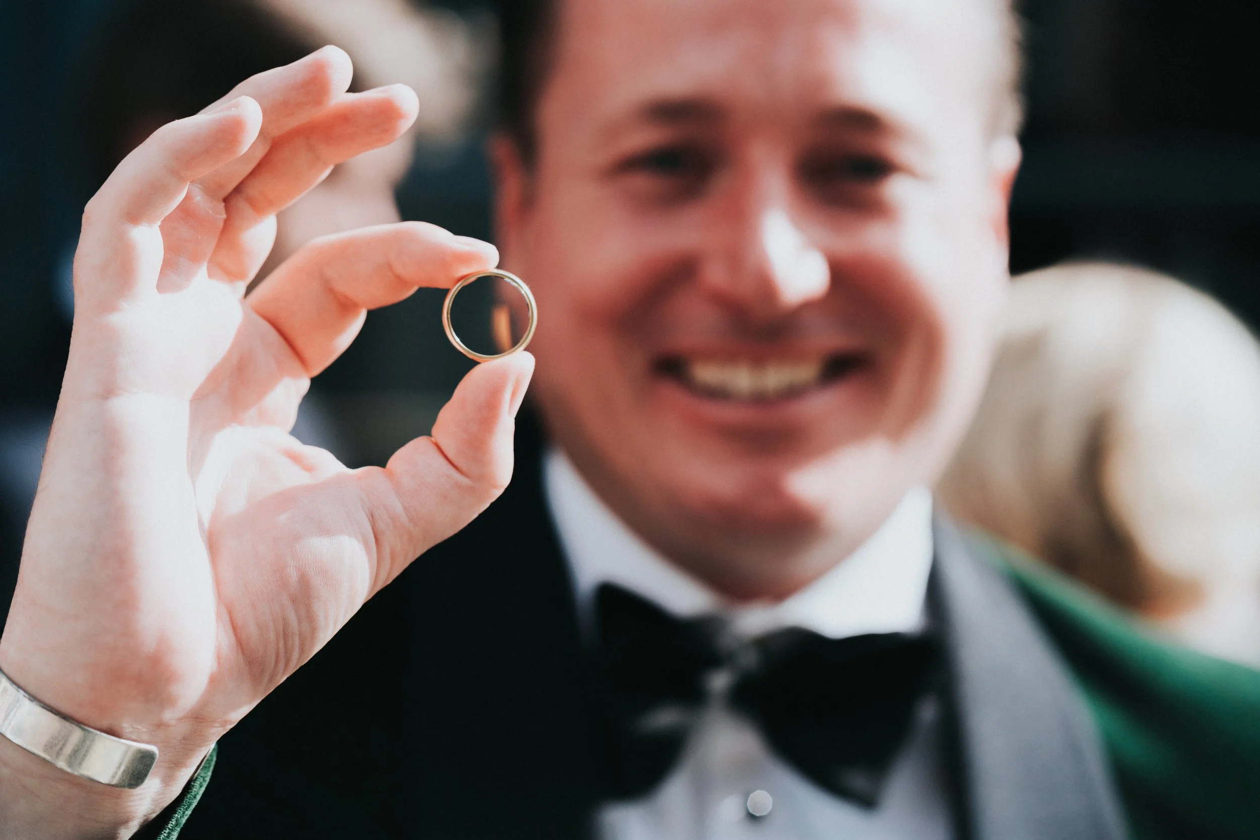 Groom showing his wedding ring to the camera at a Old Marylebone Town Hall Wedding