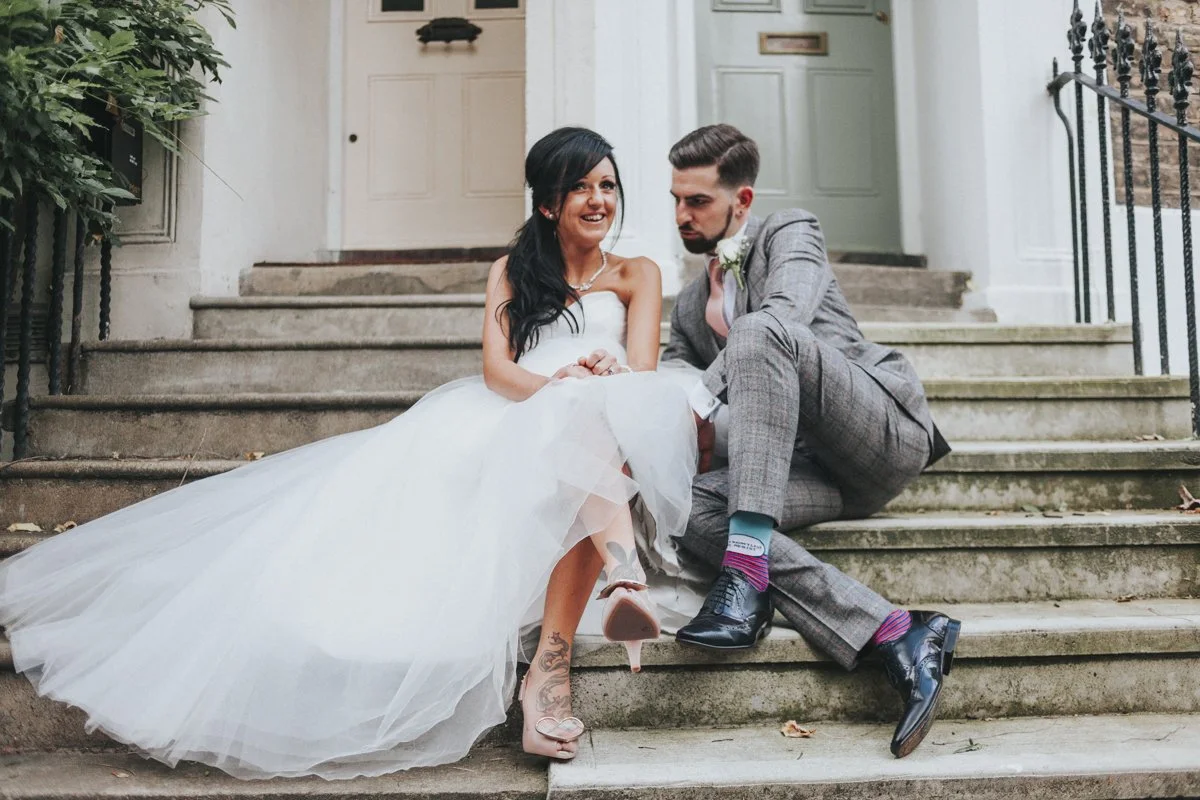 Bride & Groom posing on a doorstep near Islington Town Hall Wedding Venue