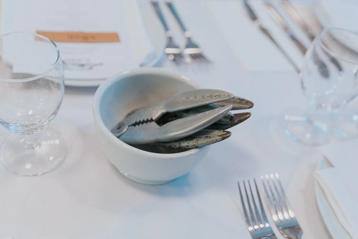 Lobster claw shaped shell crackers in a bowl on a table at St John Restaurant, Smithfield at a City of London Wedding.