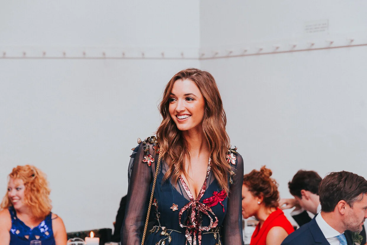 Guest walking through the reception smiling at St John Restaurant, Smithfield at a City of London Wedding.