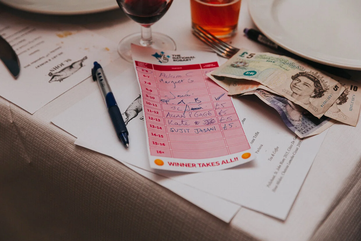 A lottery ticket with money notes and a pen at the reception at St John Restaurant, Smithfield at a City of London Wedding.