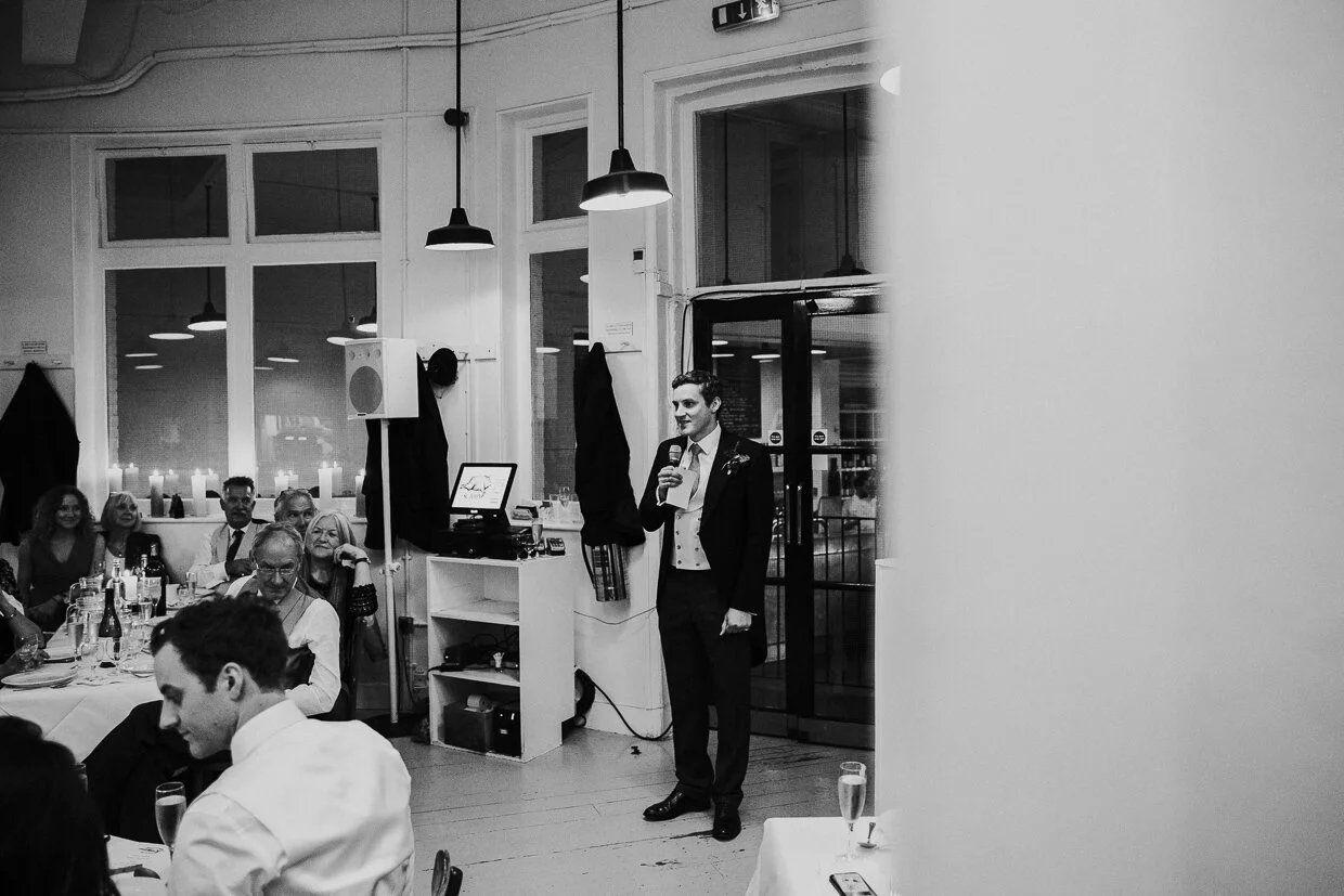 Groom giving a speech at the front of guests in the reception room at St John Restaurant, Smithfield for a City of London Wedding.