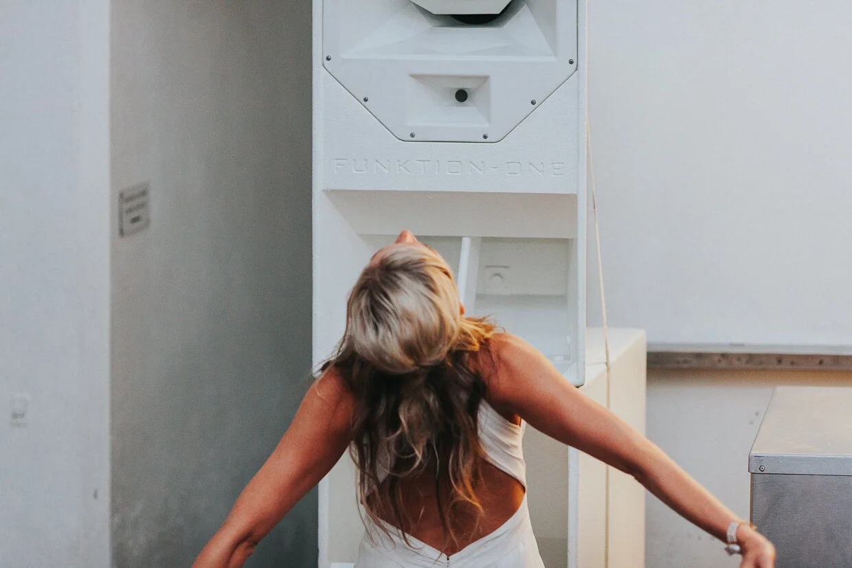 Bride standing in front of a speaker leaning back with arms open at St John Restaurant, Smithfield at a City of London Wedding.