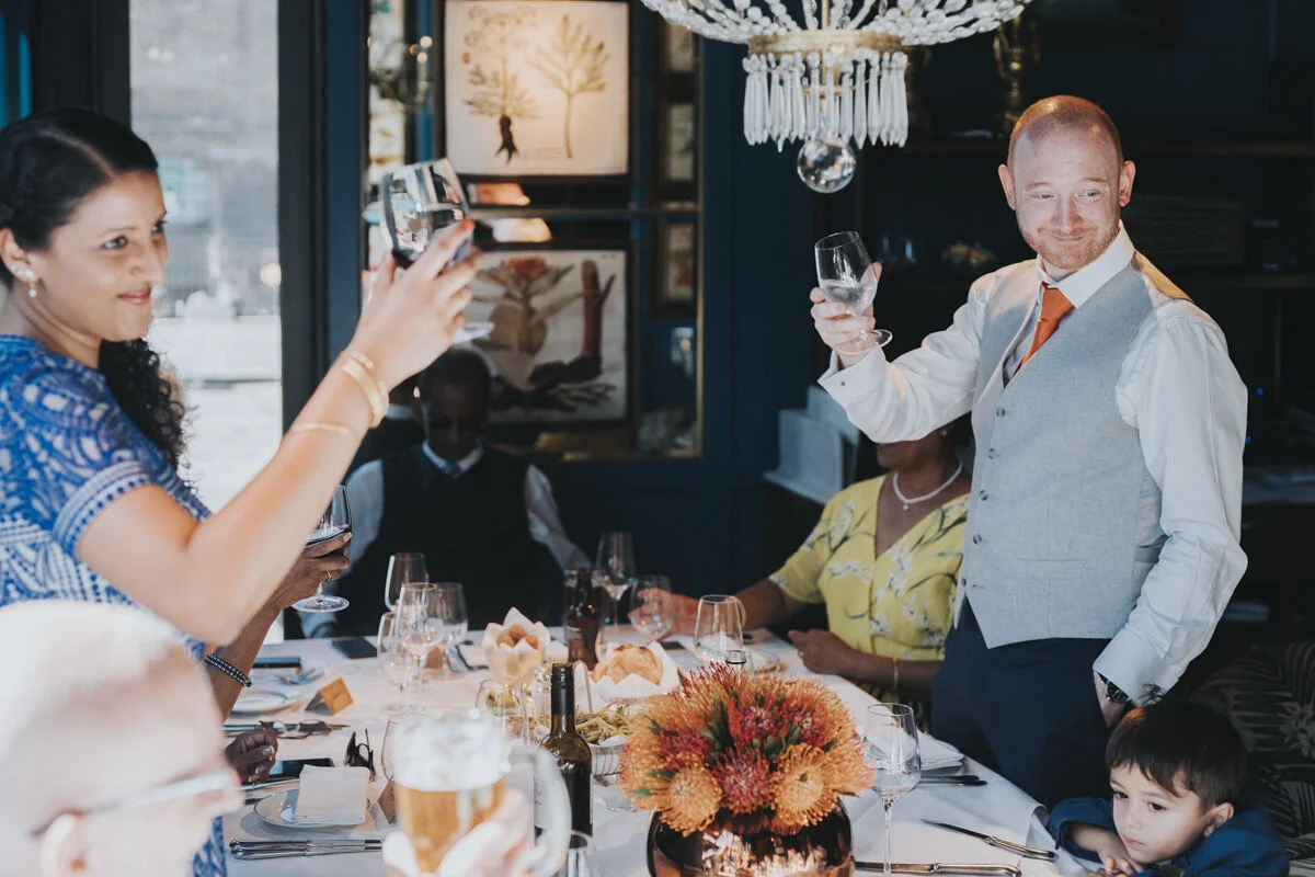 Wedding couple standing and toasting the table at a restaurant in Kings Cross for a London Wedding.