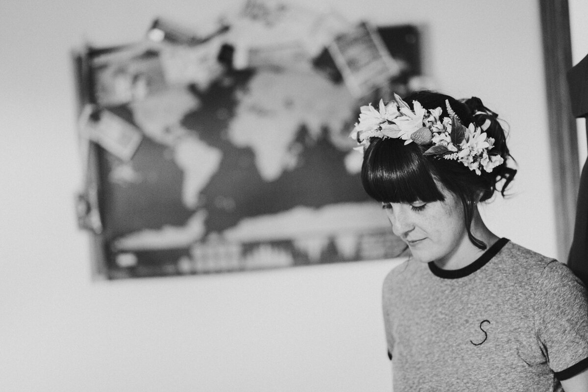 Bride in a tshirt and looking down wearing a Flower Crown at a London Wedding