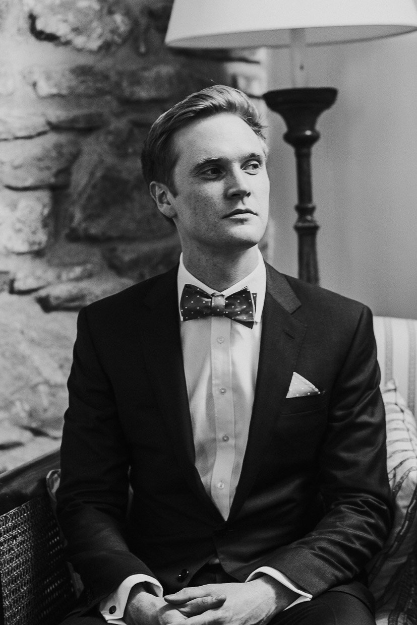 Portrait of the groom sitting in an armchair on the Ballynatray Estate for a Cork Wedding