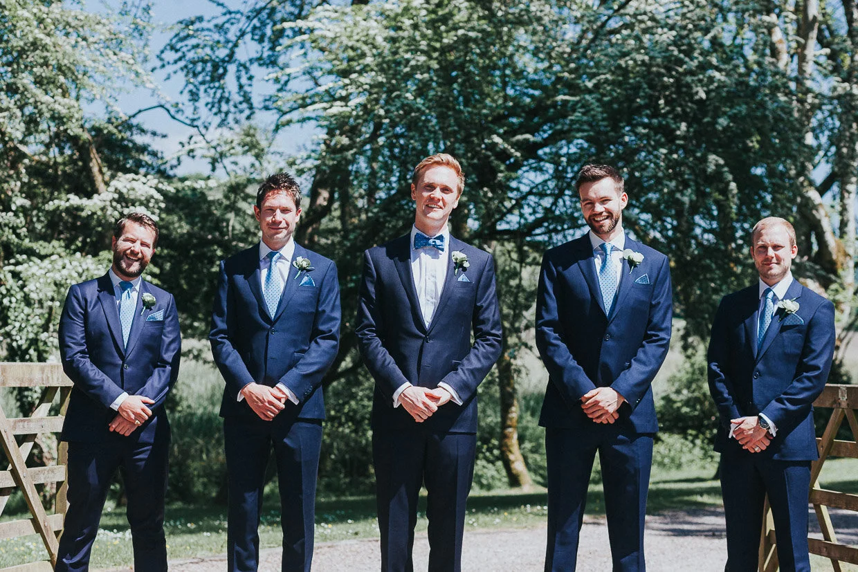 Group shot of groomsmen with Groom front and centre on the Ballynatray Estate for a Cork Wedding
