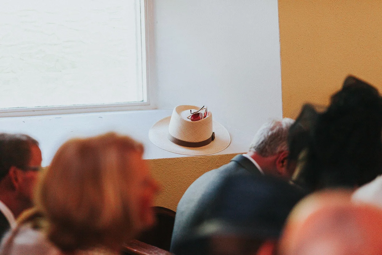 Hat with sunglasses on top, sitting on a window ledge in the church on the Ballynatray Estate for a Cork Wedding