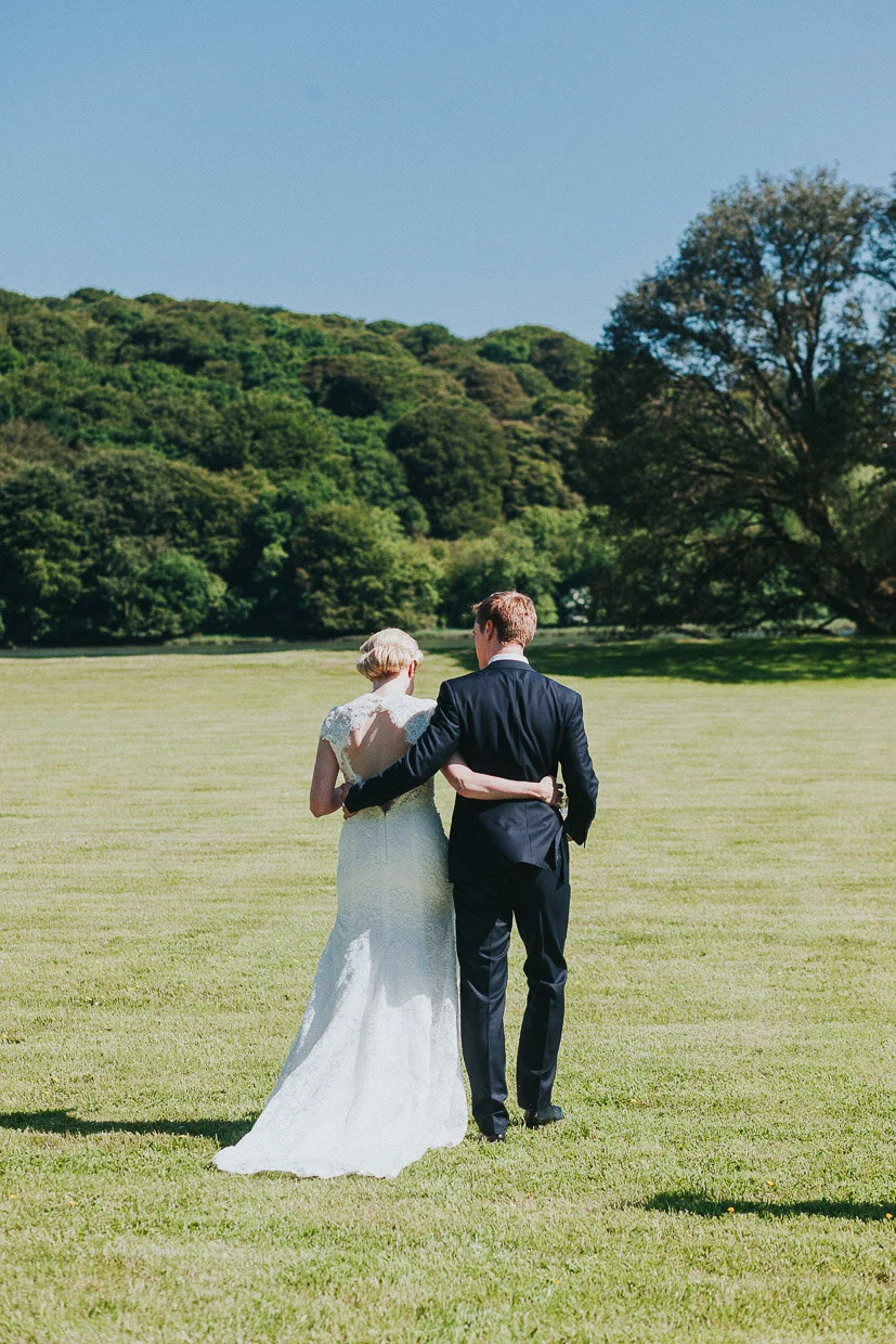 Just the bride & groom walking away from the house across the grounds on the Ballynatray Estate for a Cork Wedding