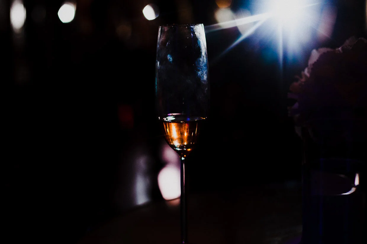Silhouette of a champagne flute with drink and a spotlight shining on it on the Ballynatray Estate for a Cork Wedding