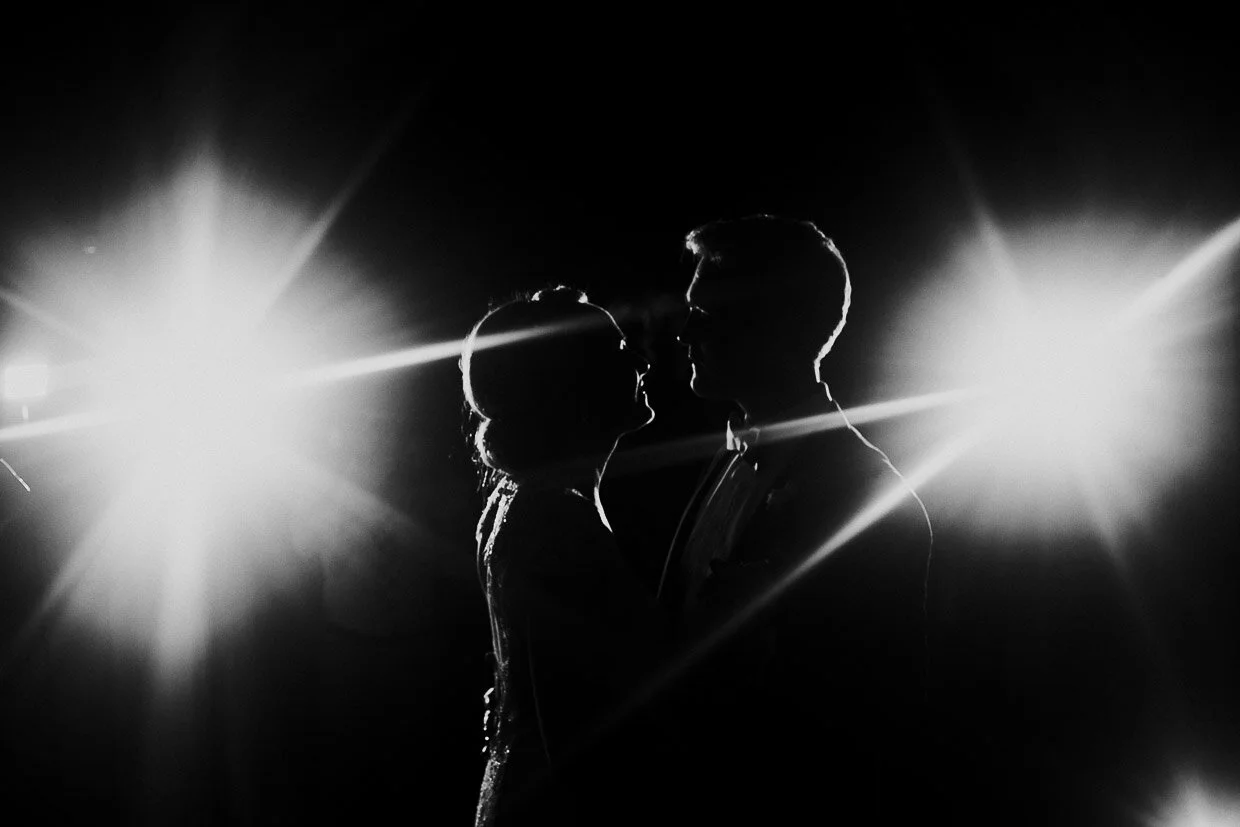 Wedding couple dancing, facing each other for their first dance in between spotlights on the Ballynatray Estate for a Cork Wedding