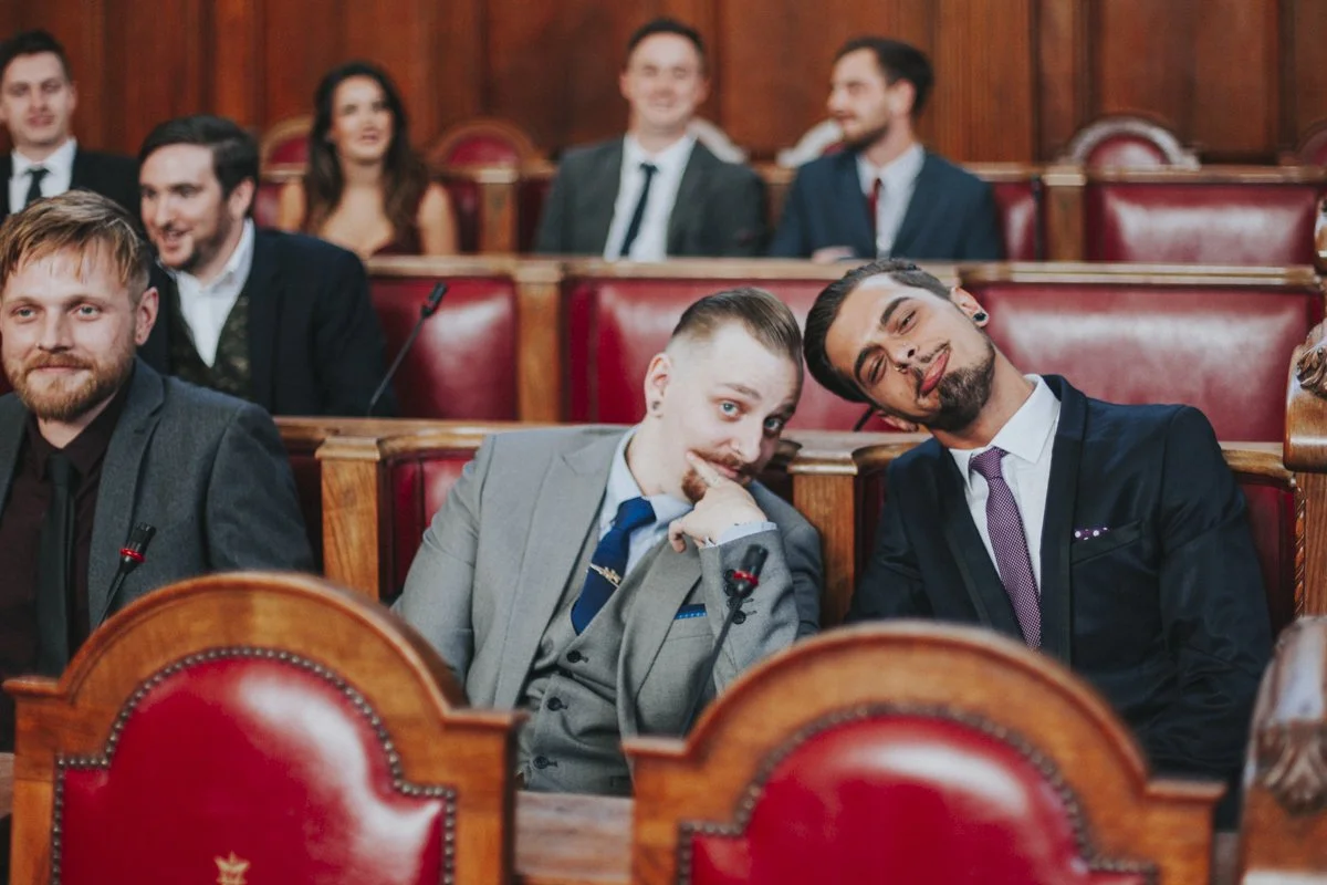 Wedding guests posing in the Council Chamber during Islington Town Hall wedding photography