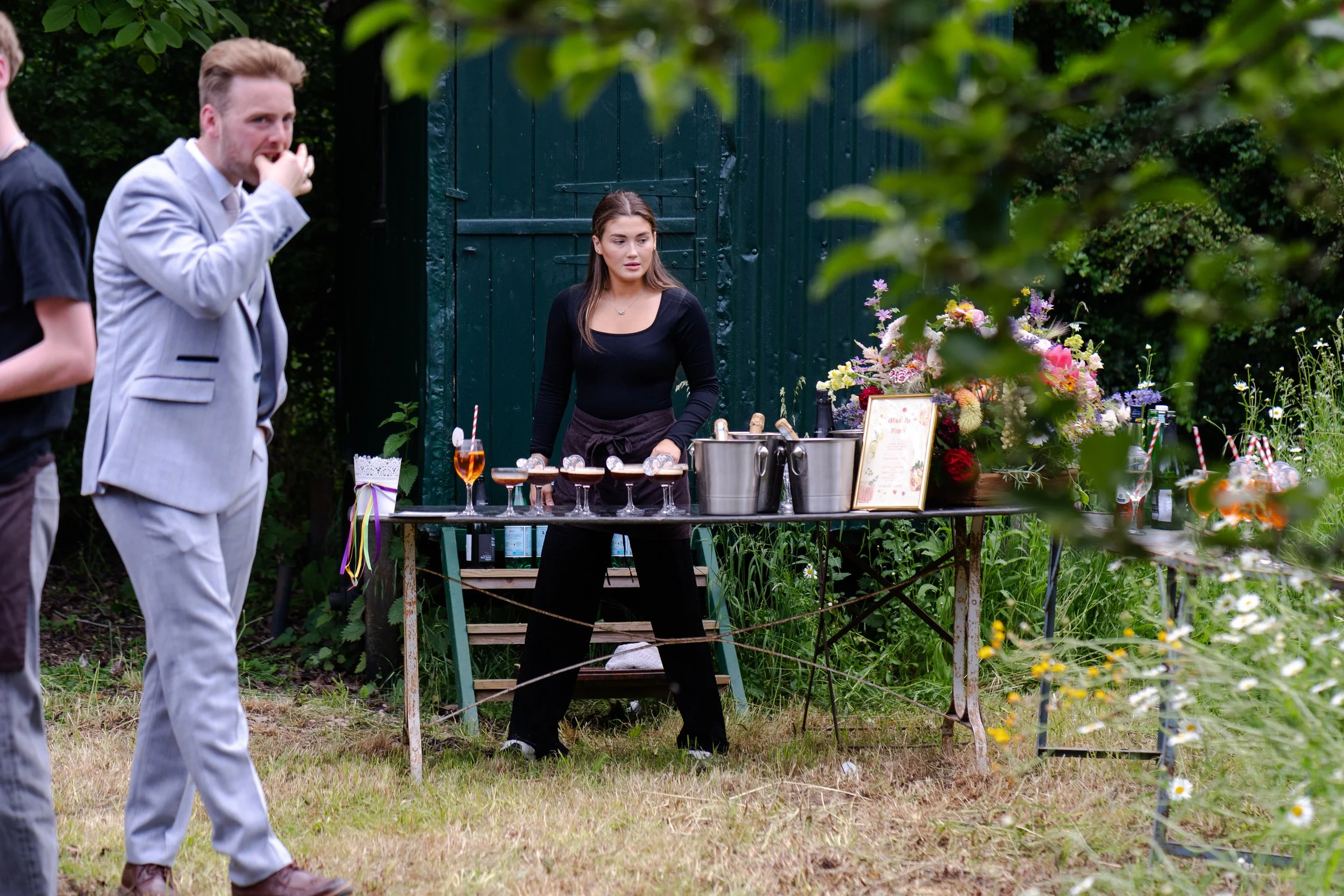 Drinks reception with cocktail making set up with staff at a Worton Kitchen Garden, Oxfordshire Wedding.