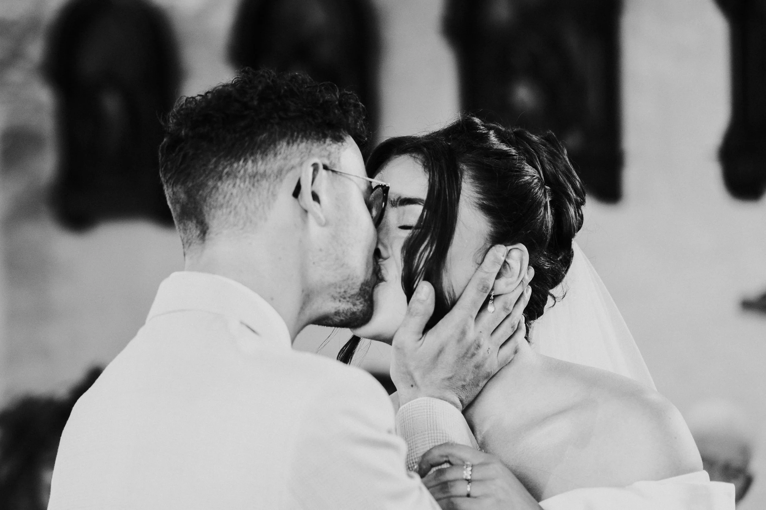 Wedding couple kissing at the front of the church at a Worton Kitchen Garden, Oxfordshire Wedding.