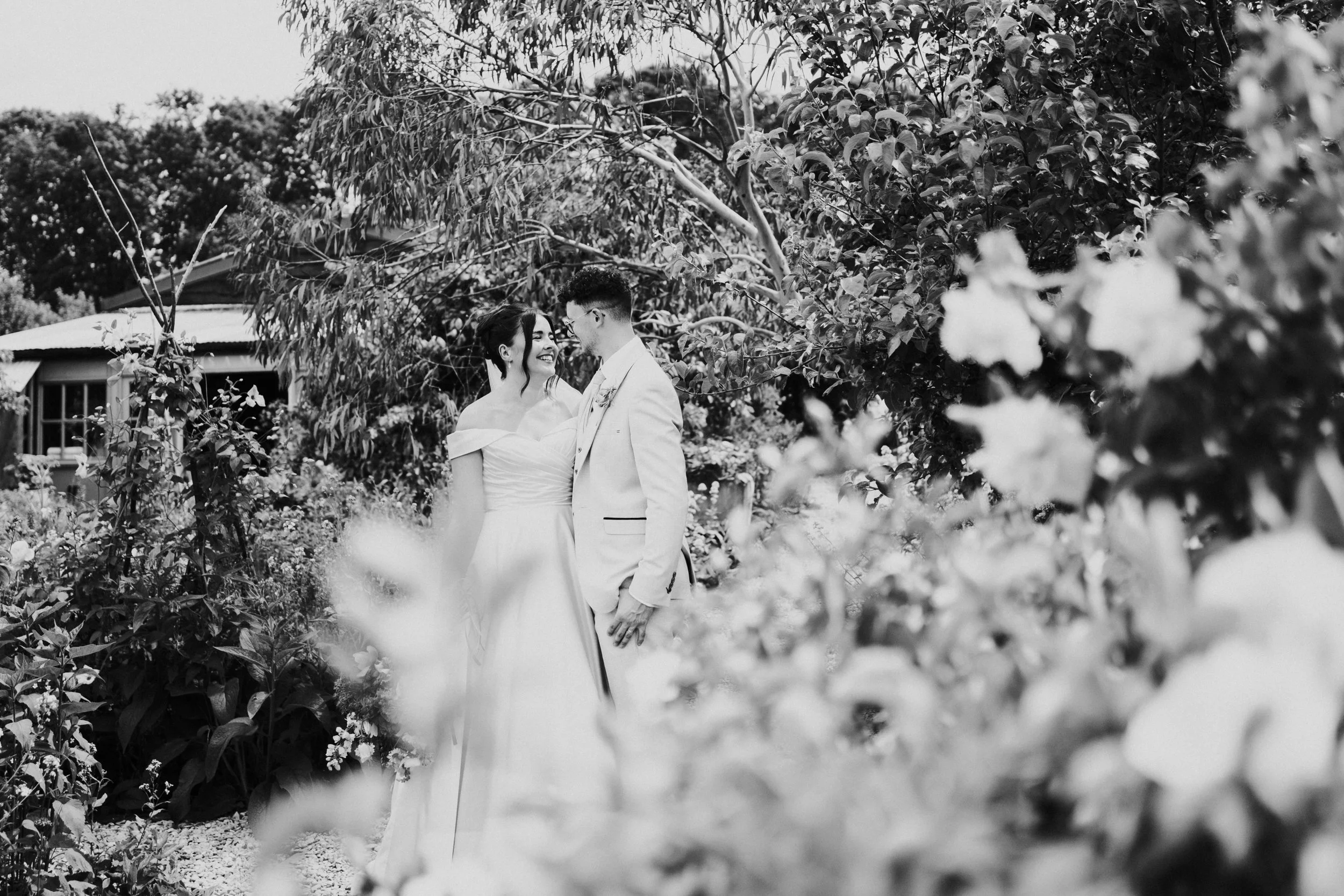Wedding couple posing in a flower garden at a Worton Kitchen Garden, Oxfordshire Wedding.