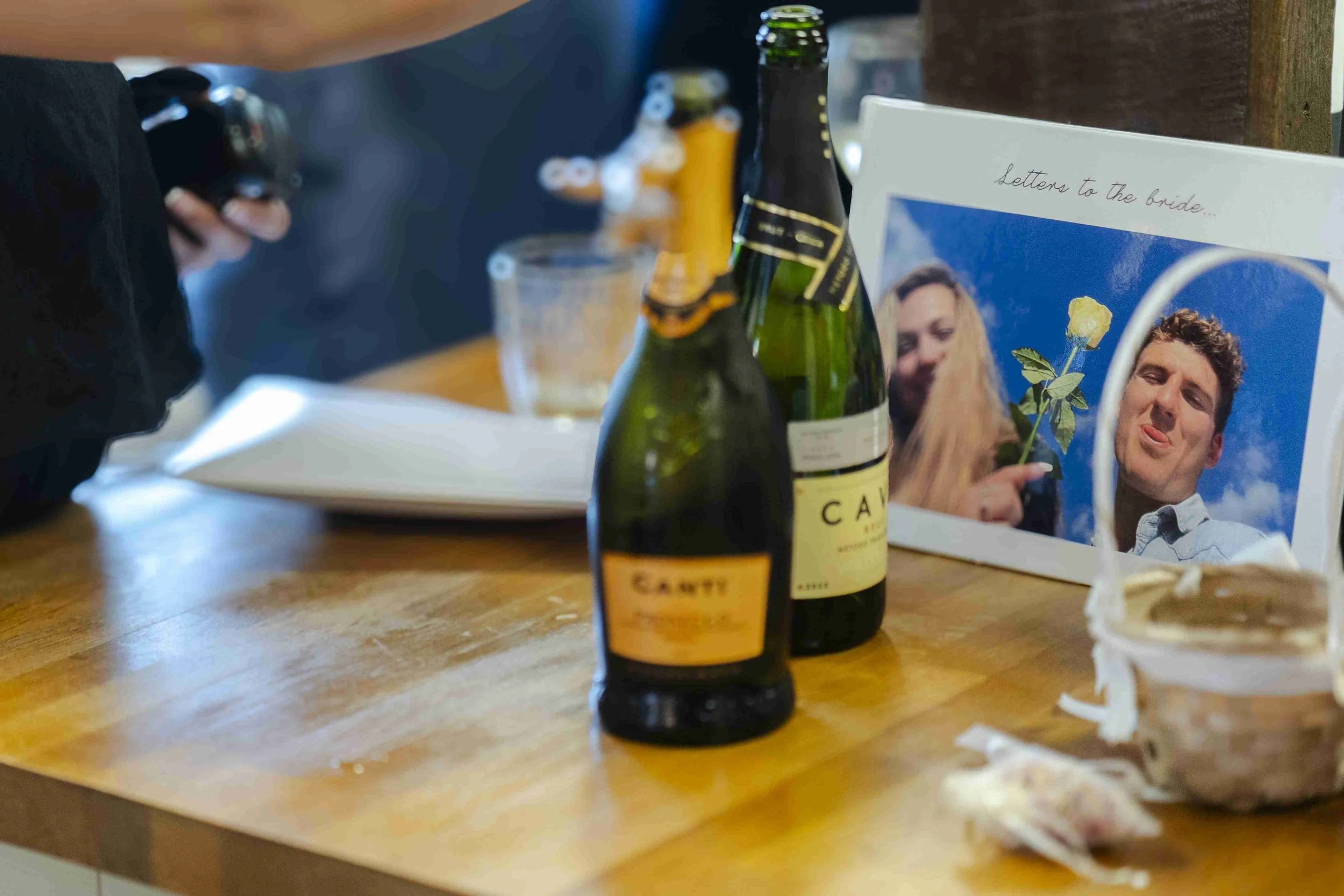 Prosecco bottles in front of a card with the image of the bride and groom with the words, Letter to the bride, before the Halfmoon Farm Wedding in Rutland