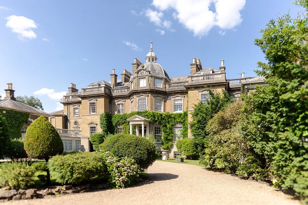 A wide view of Hampton Court House with the driveway and front garden at a Surrey Wedding.