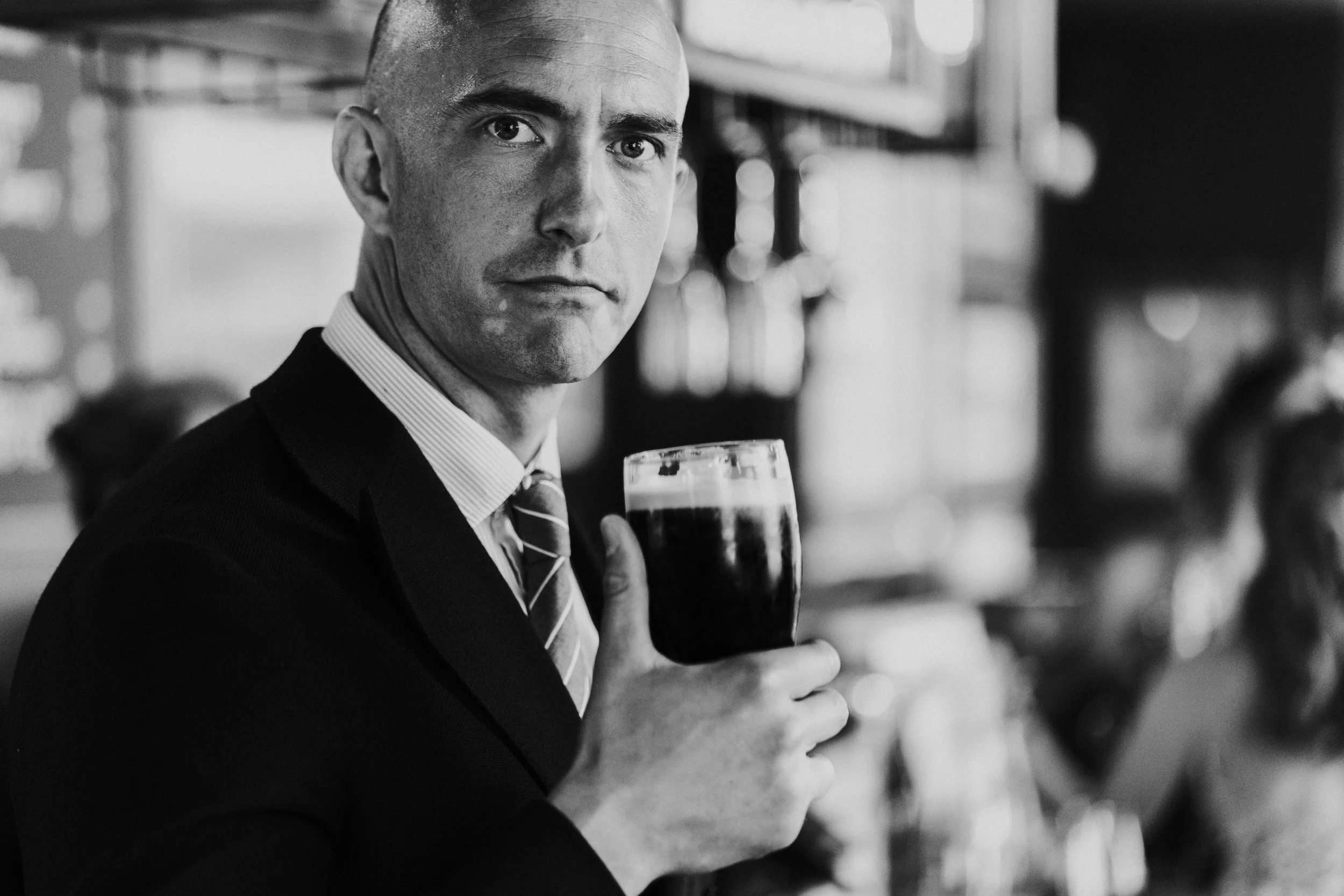 Wedding guest staring at the camera with a pint of Guinness at a Old Marylebone Town Hall Wedding