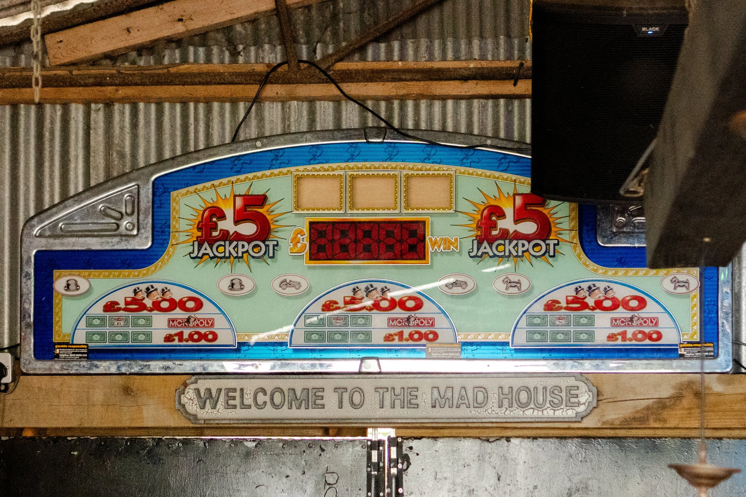 Old Scoreboard hanging in the barn with a sign under saying Welcome to the Mad House at a rhyse farm wedding