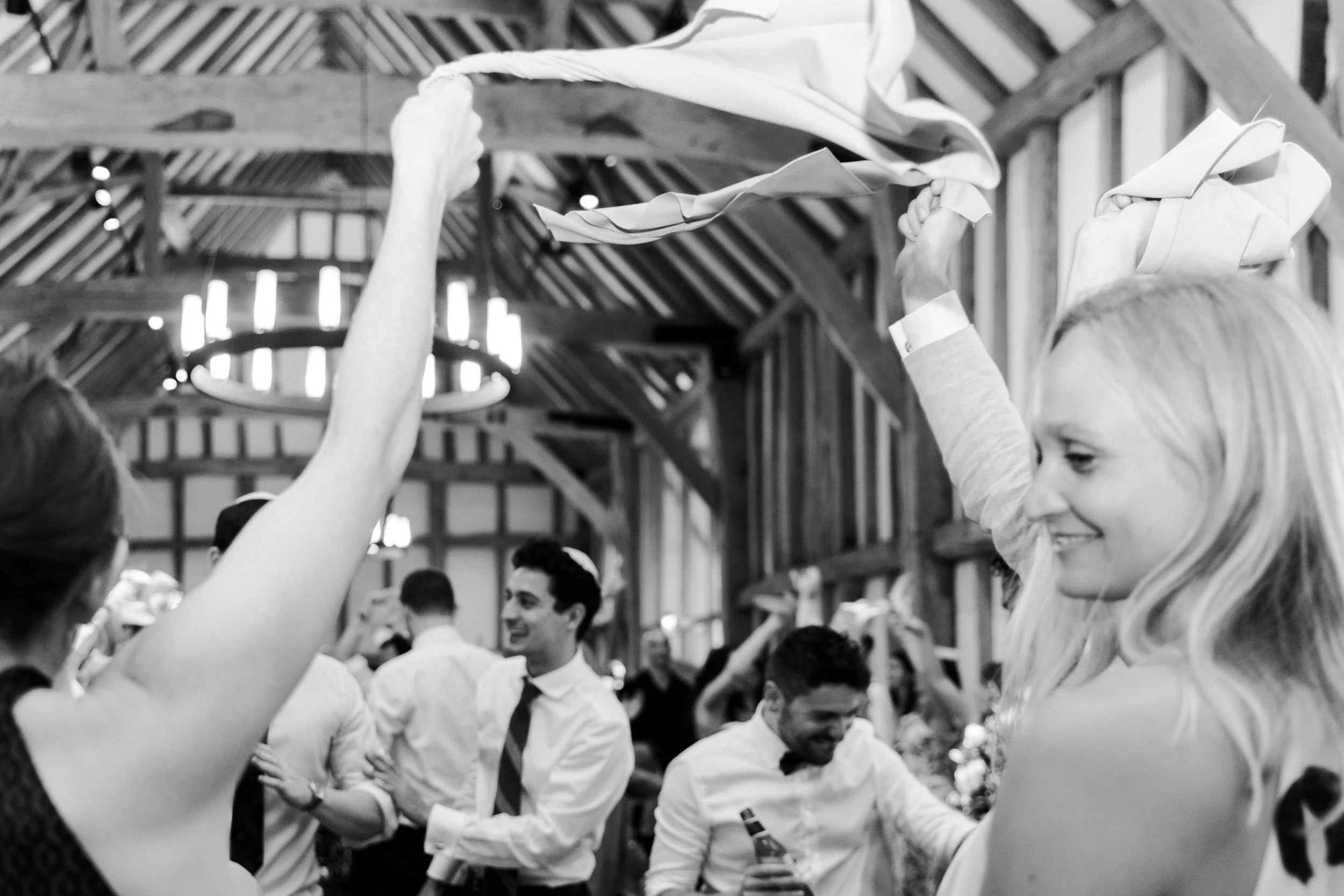 Wedding guest waving their handkerchiefs above their heads at a Micklefield Hall Wedding