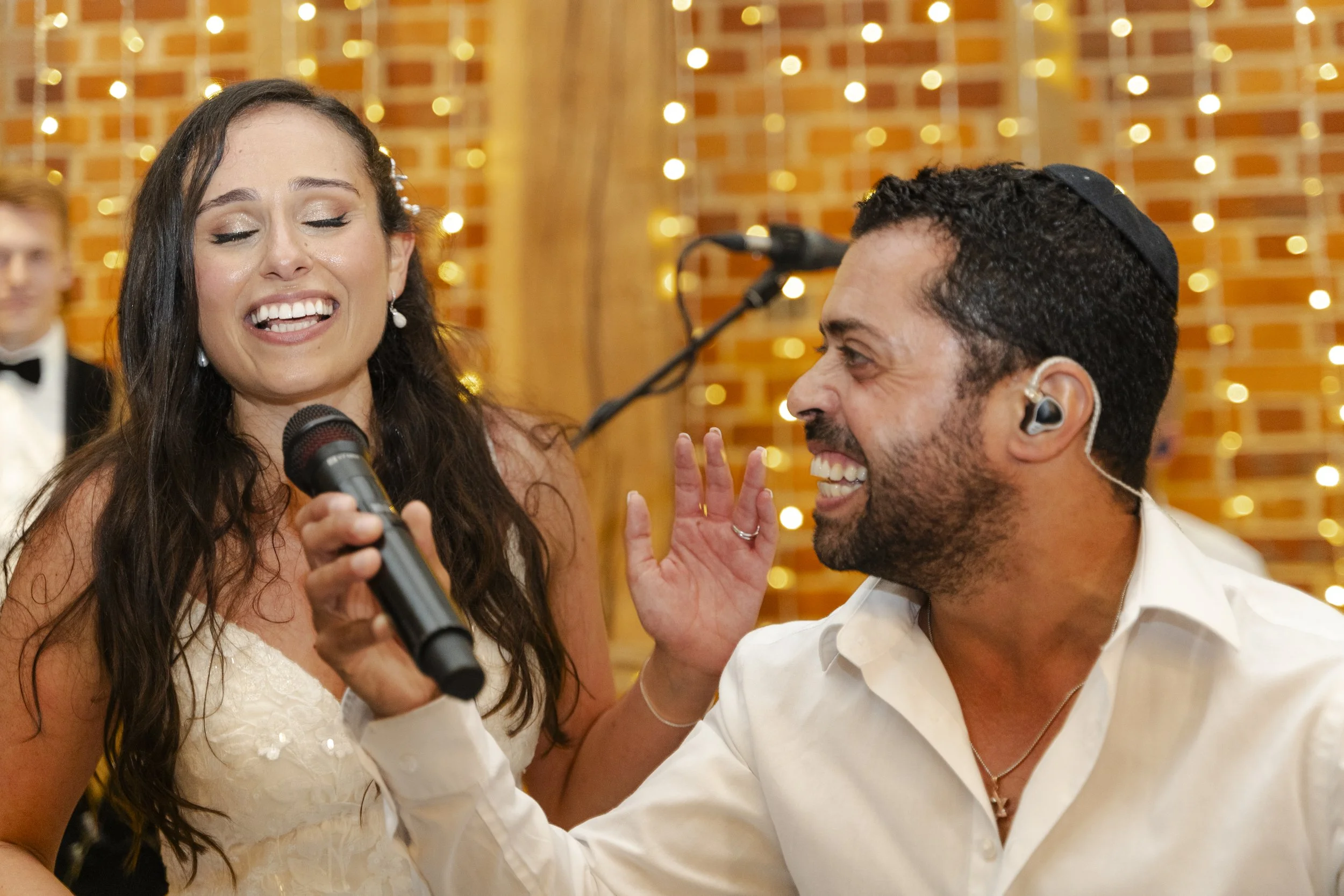 Bride singing at a wedding reception with the singer holding the microphone at a Micklefield Hall Wedding
