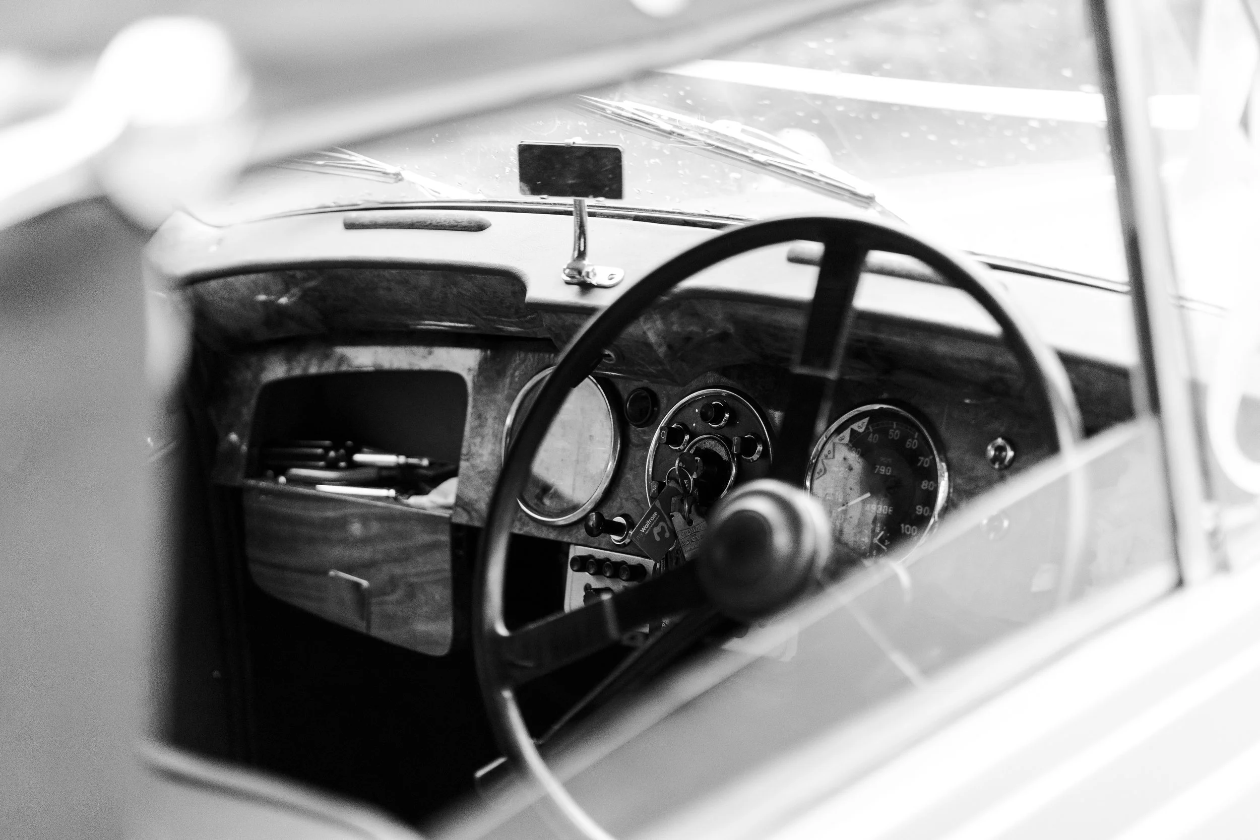 View of the dashboard inside the wedding car with the top down before a Highgate, London Wedding