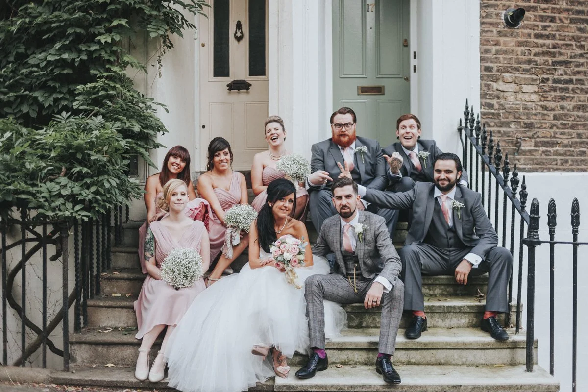 Bridal Party sitting on a doorstep of a town house near Islington Town Hall Wedding Venue