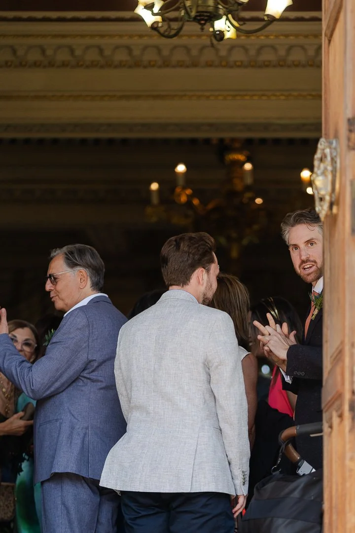 The Groom standing by the opened front door of Hampton Court House before his London Wedding.