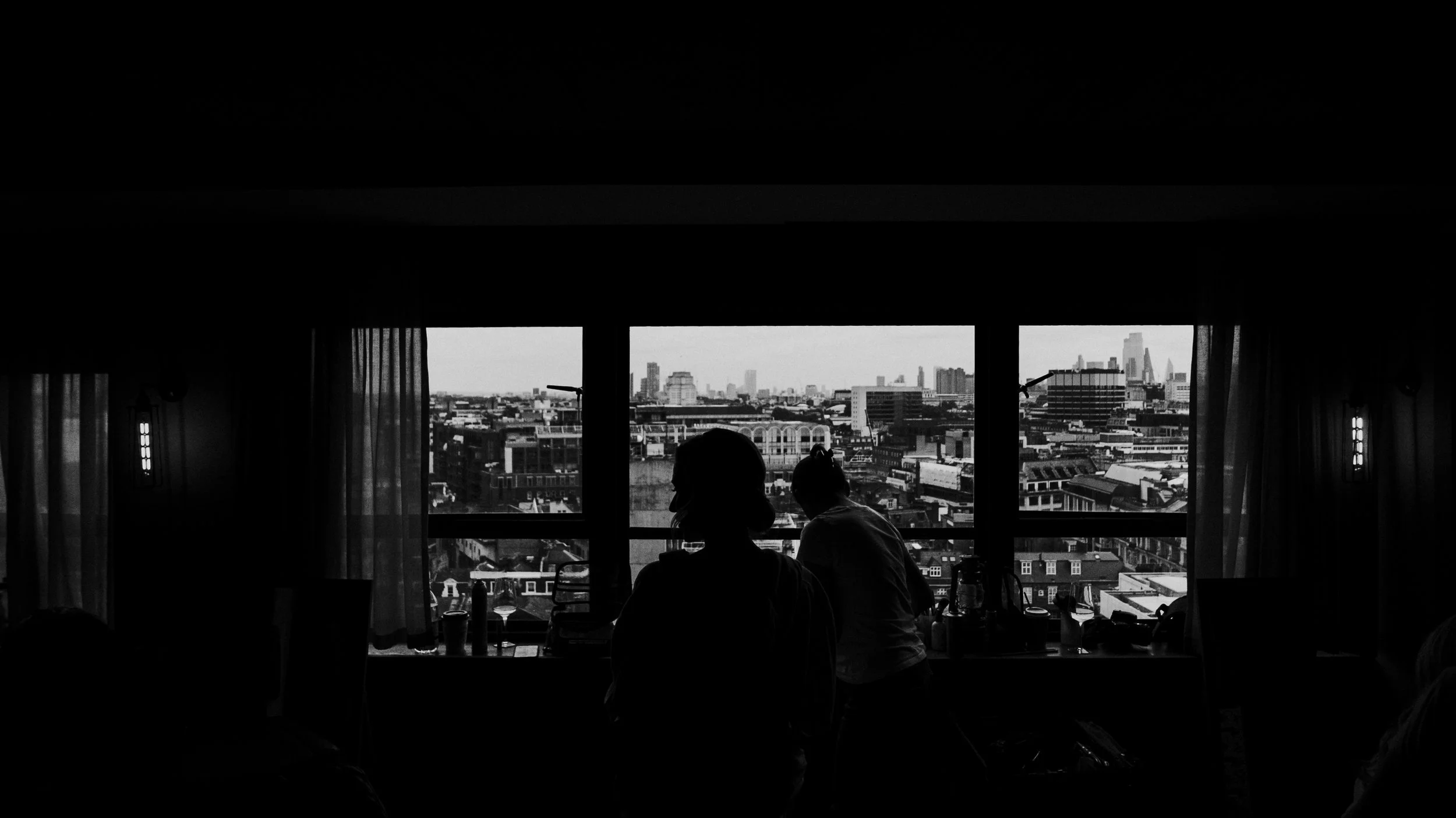 Silhouette of the bride in the makeup chair with a window view of London at The Treehouse, London before a Old Marylebone Town Hall Wedding Photography