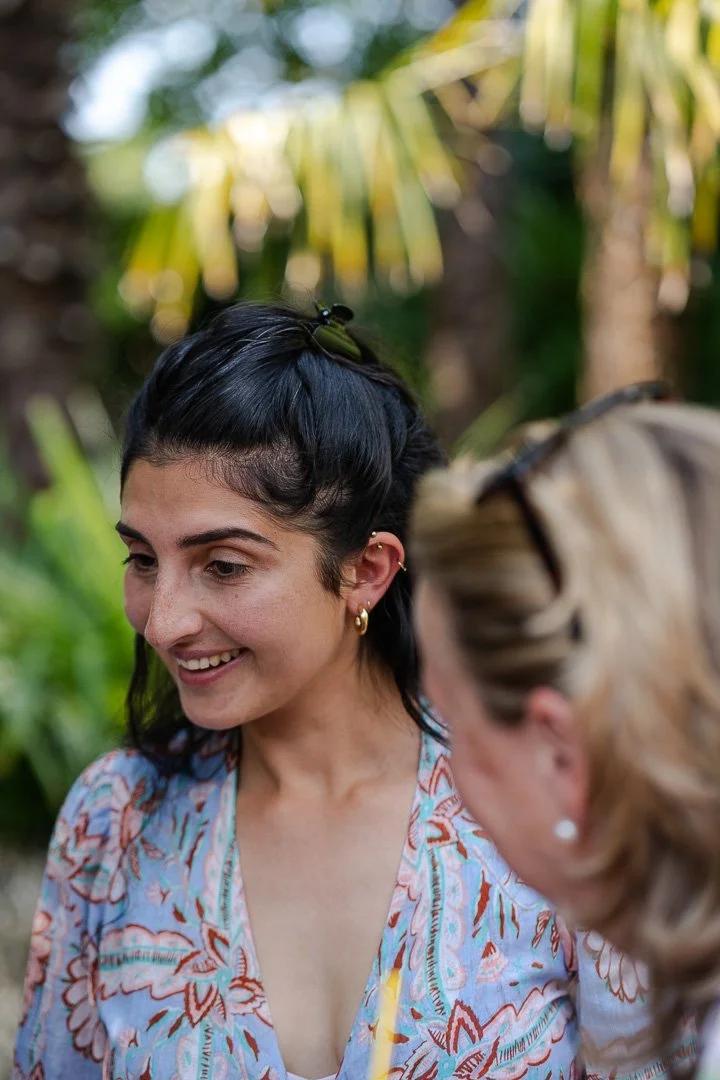 A guest looking away from the camera is smiling at a Hampton Court House Wedding.