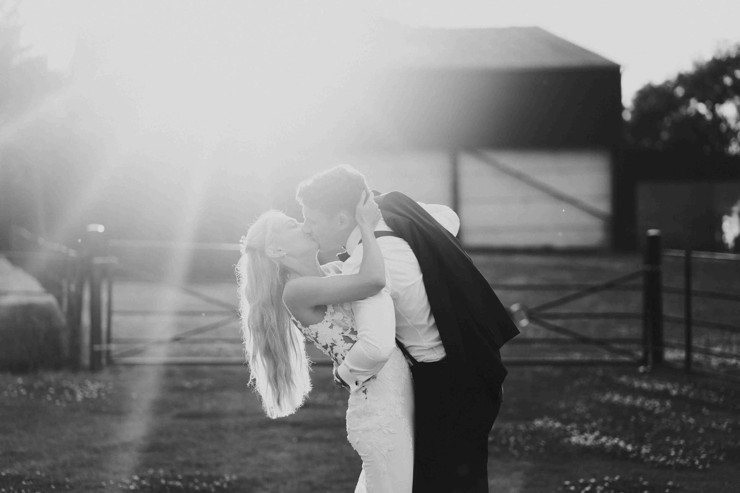 The groom dipping the bride while kissing her at the Halfmoon Farm Wedding in Rutland