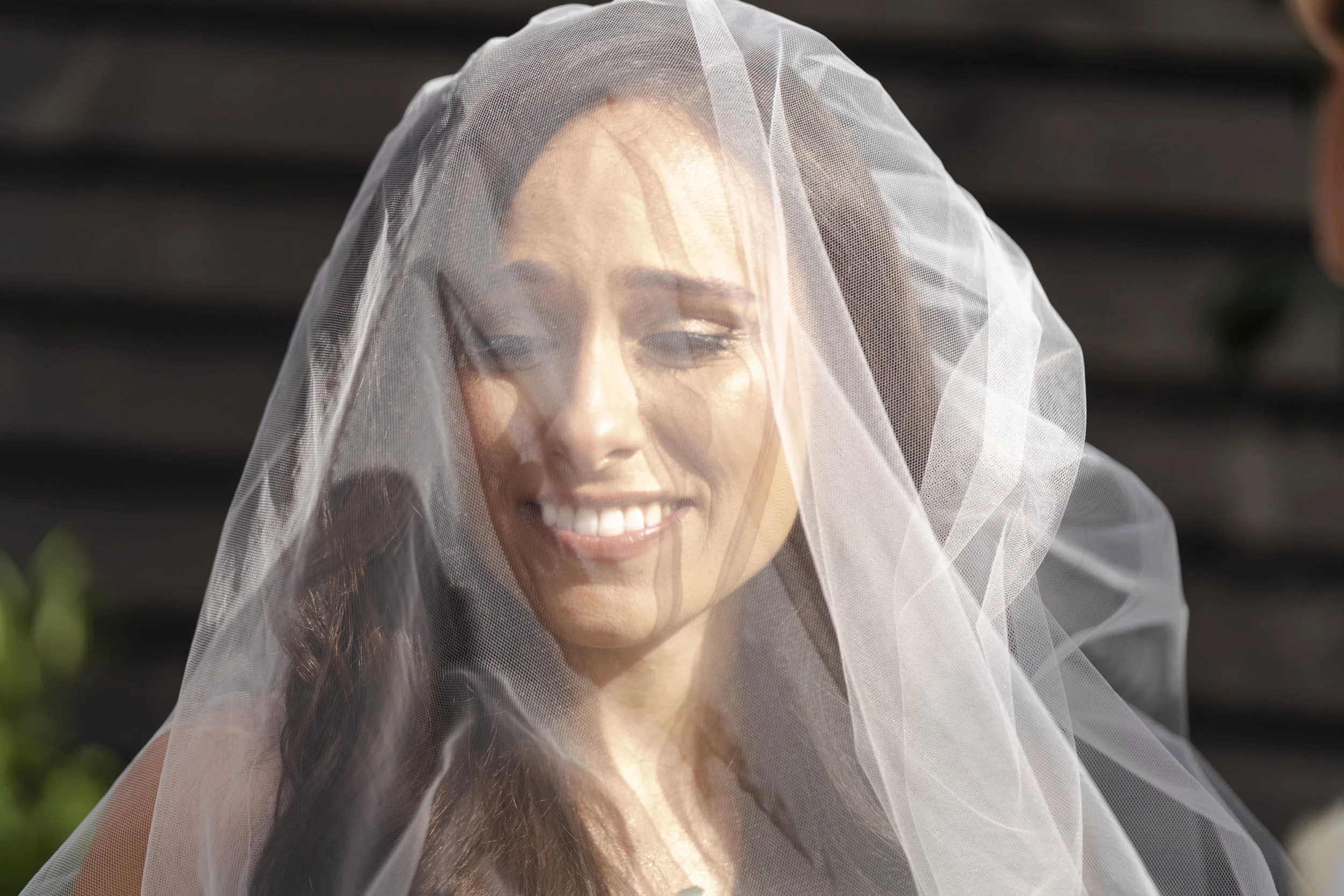 Bride smiling and looking emotional at The Temple during the wedding ceremony at a Micklefield Hall Wedding