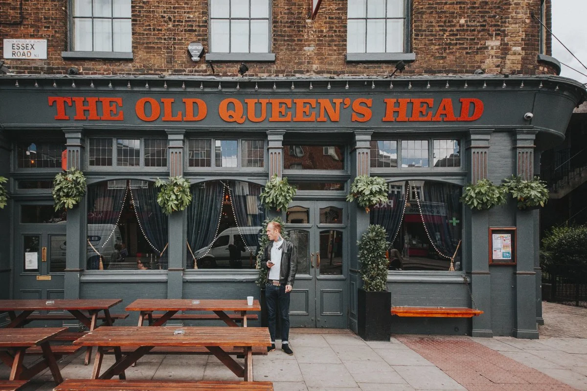 Guest standing outside the front of the iconic The Old Queens Head pub on Essex Road, Islington