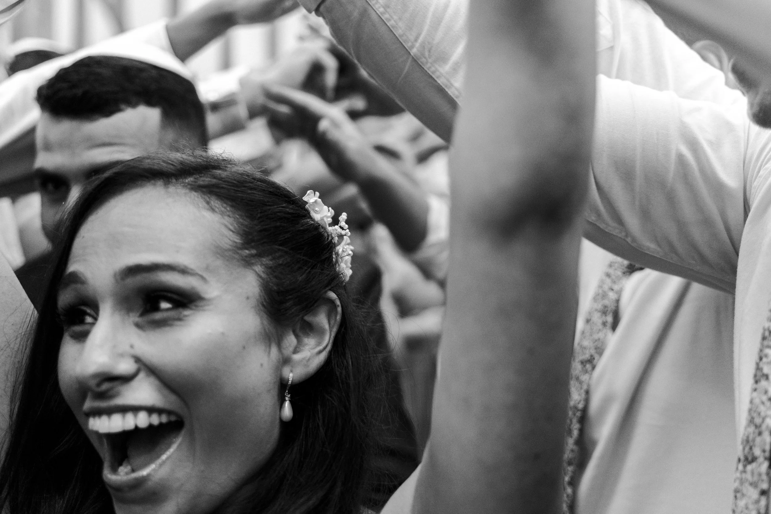 Bride smiling at the end of the humn tunnel at a Micklefield Hall Wedding
