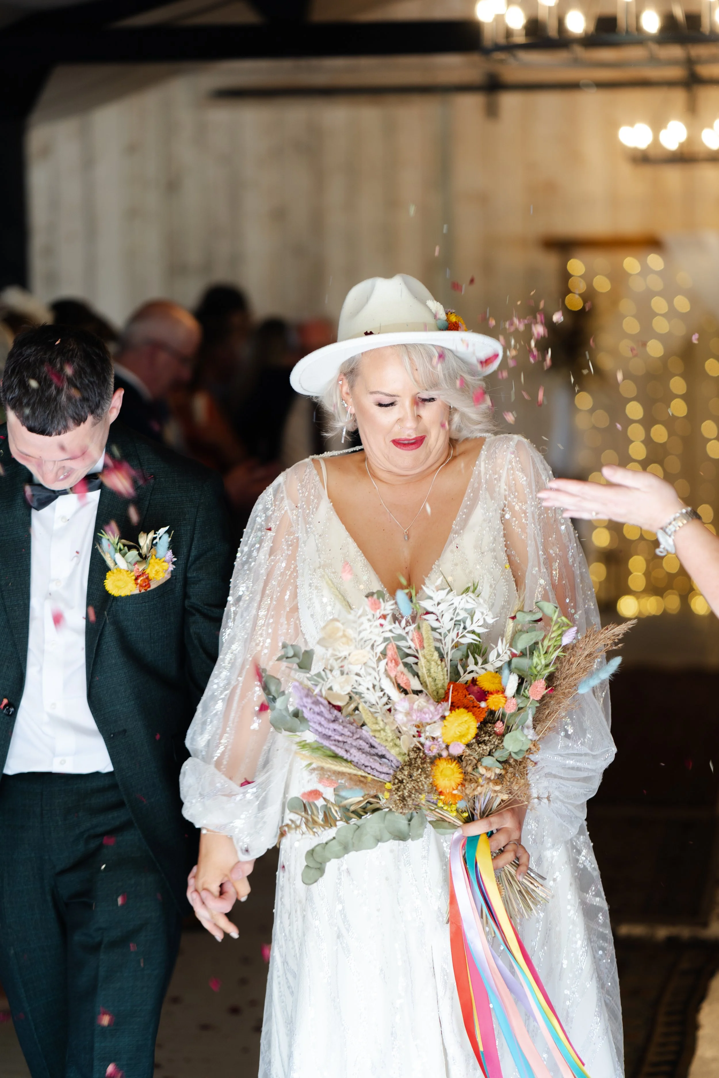 Wedding couple exiting the ceremony while be showered with confetti at a rhyse farm wedding