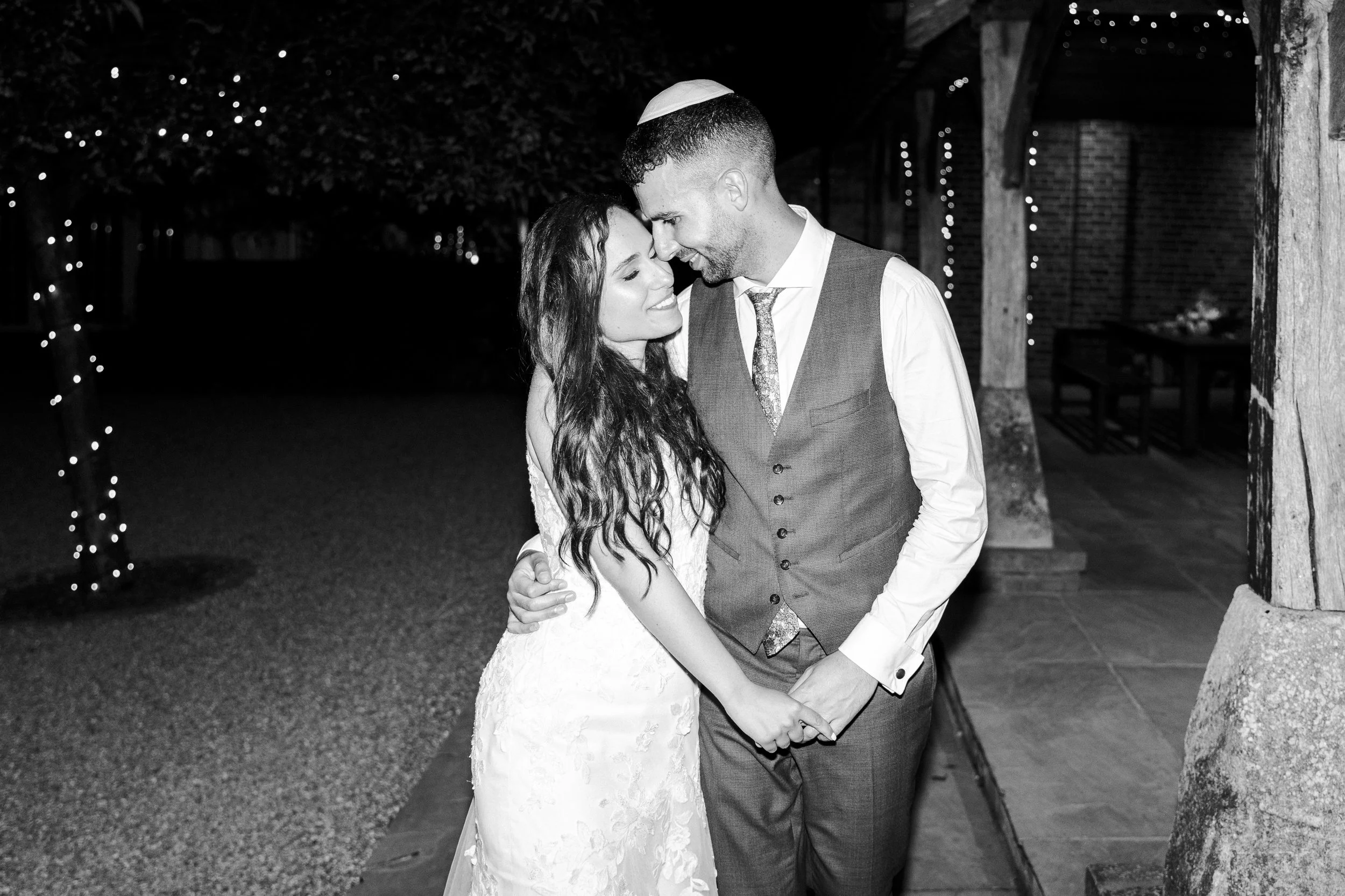 Wedding couple walking during the late evening holding hands and heads together at a Micklefield Hall Wedding
