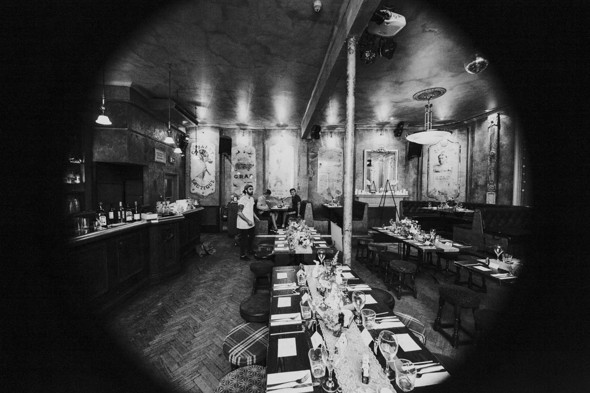 Wedding reception set up image taken through a distorted lens at the iconic The Queens Head, Essex Road, Islington for a London Wedding