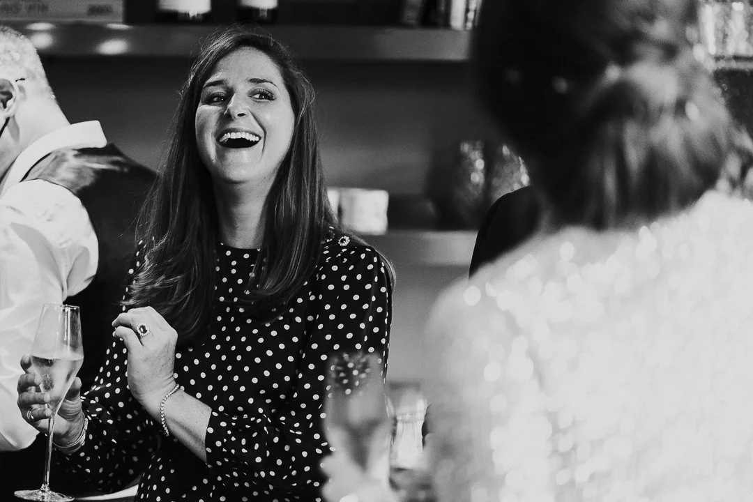 Wedding guest looking another guest laughing at a restaurant at the Old Marylebone Town Hall Wedding.