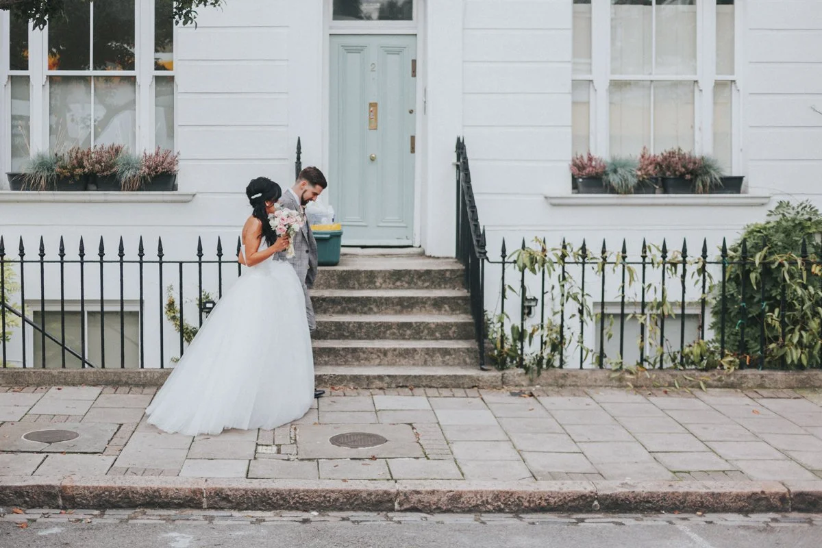 Bride & Groom walking down the street side by side near Islington Town Hall Wedding