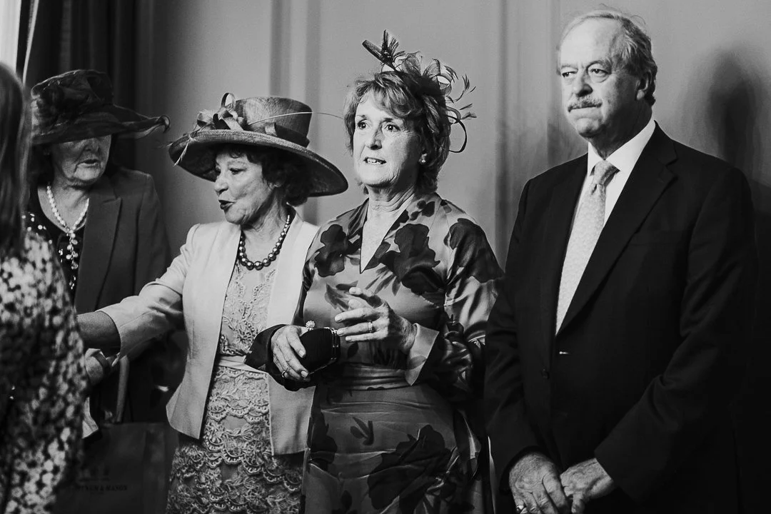 Groom parents & Bride's mum greeting guests in the ceremony room at the Old Marylebone Town Hall Wedding.